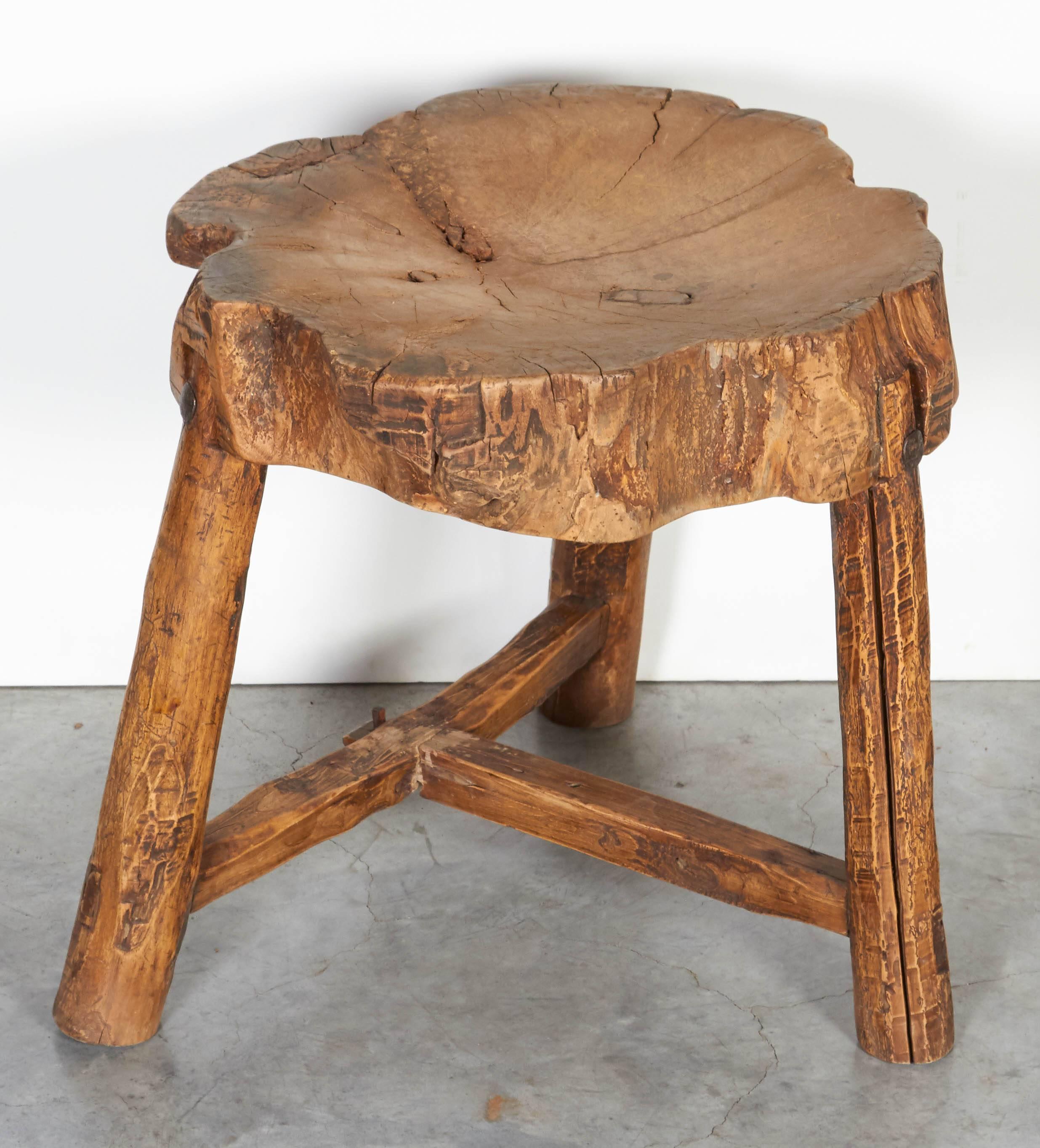 A Primitive, nicely shaped thick seated stool originally used as a butcher block in a rural province of China. The perfectly worn seat and legs add warmth and interest to any space. From Shandong Province, circa 1920.
a b h a y a 
S318.