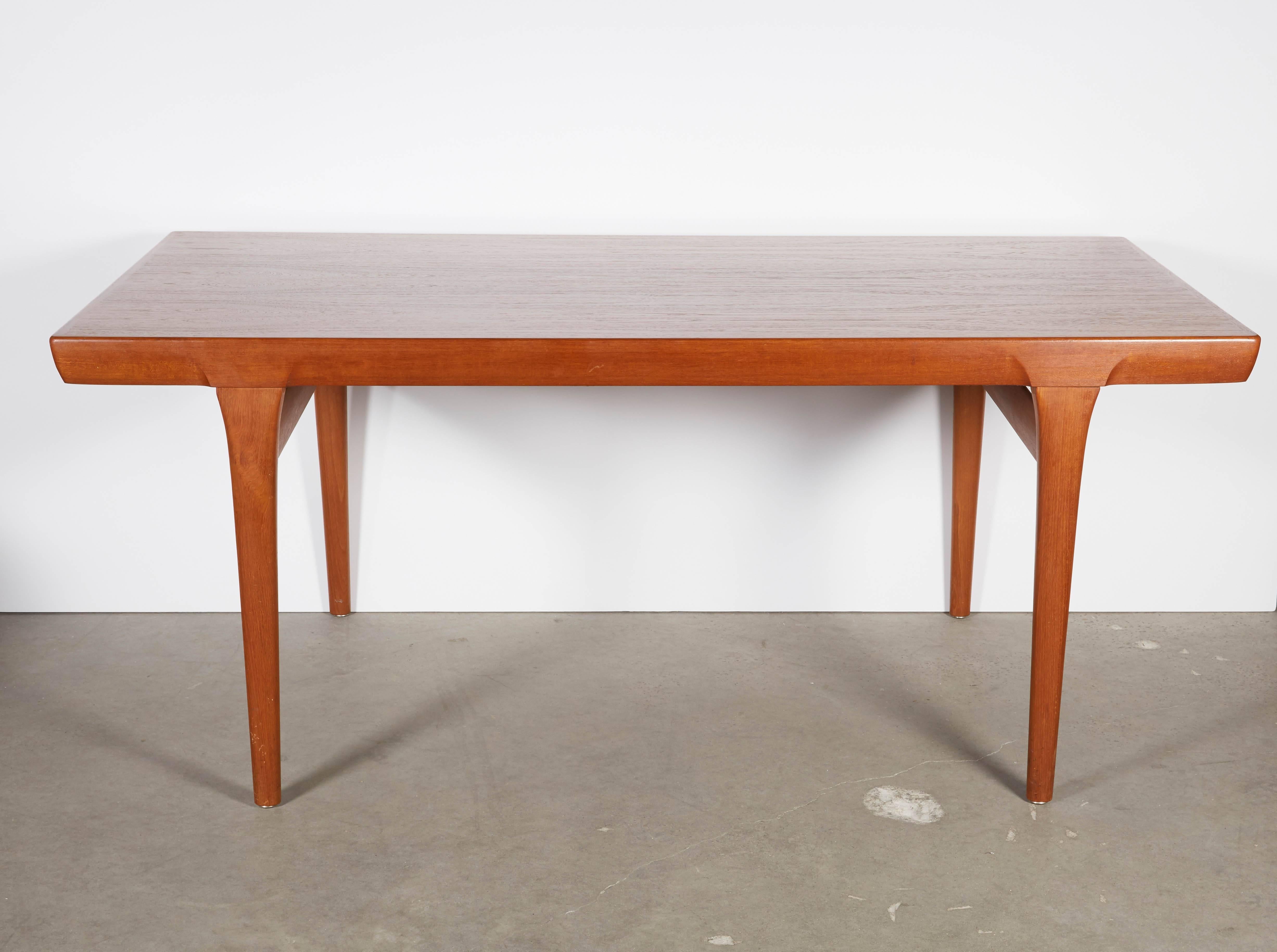 Vintage 1960s Ib Kofod-Larsen Dining Table with 2 Leaves

This expandable teak dining table is in excellent condition, and has 2 leaves that store under the top of the table. Leaves are 14" each, the table seats 10 people or more if someone