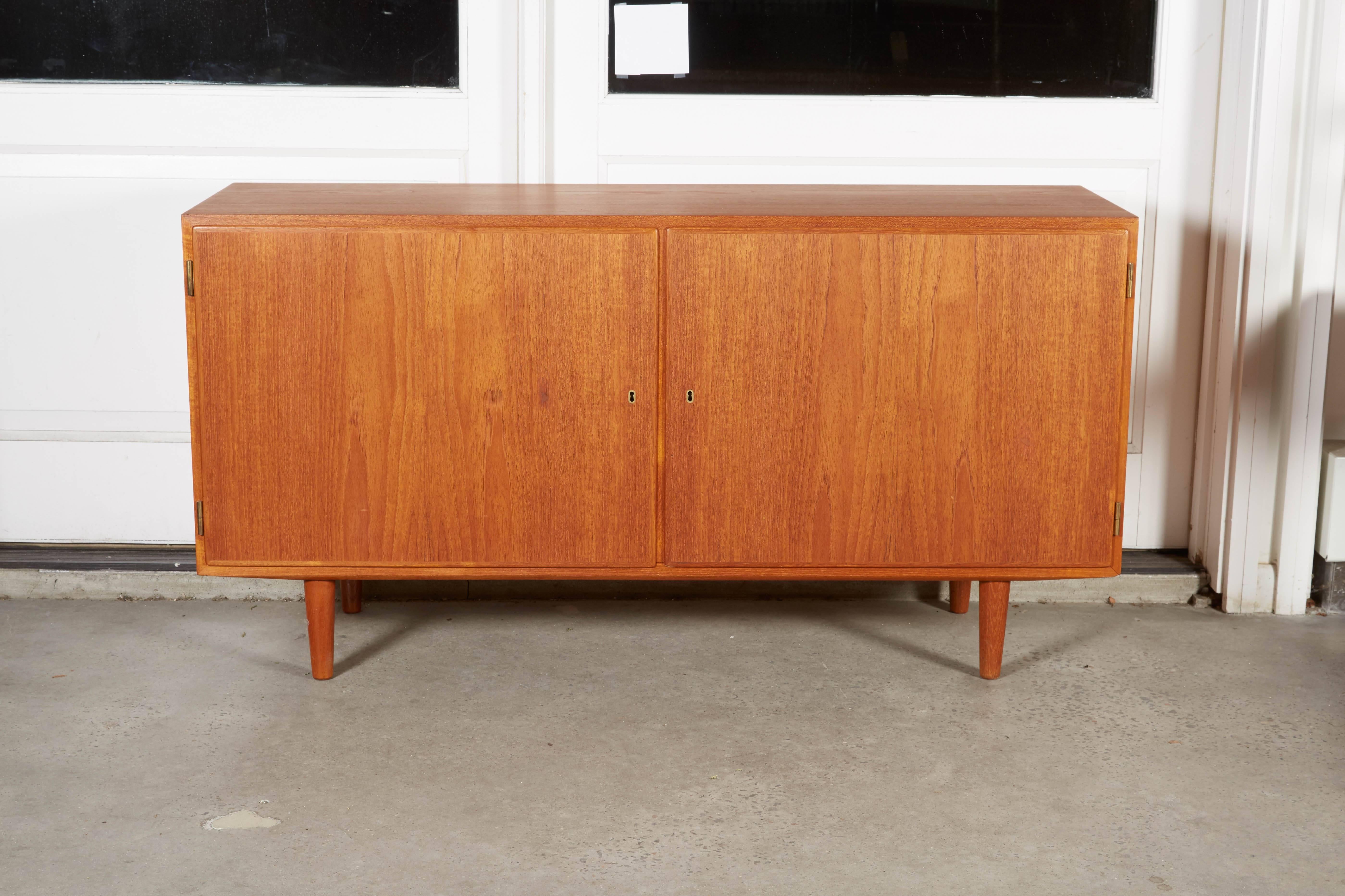 Vintage 1960s Kai Winding Teak Credenza

This mid century sideboard is in excellent condition, like new. Great for media, or dining room storage. Has key. Ready for pick up, delivery, or shipping anywhere in the world.