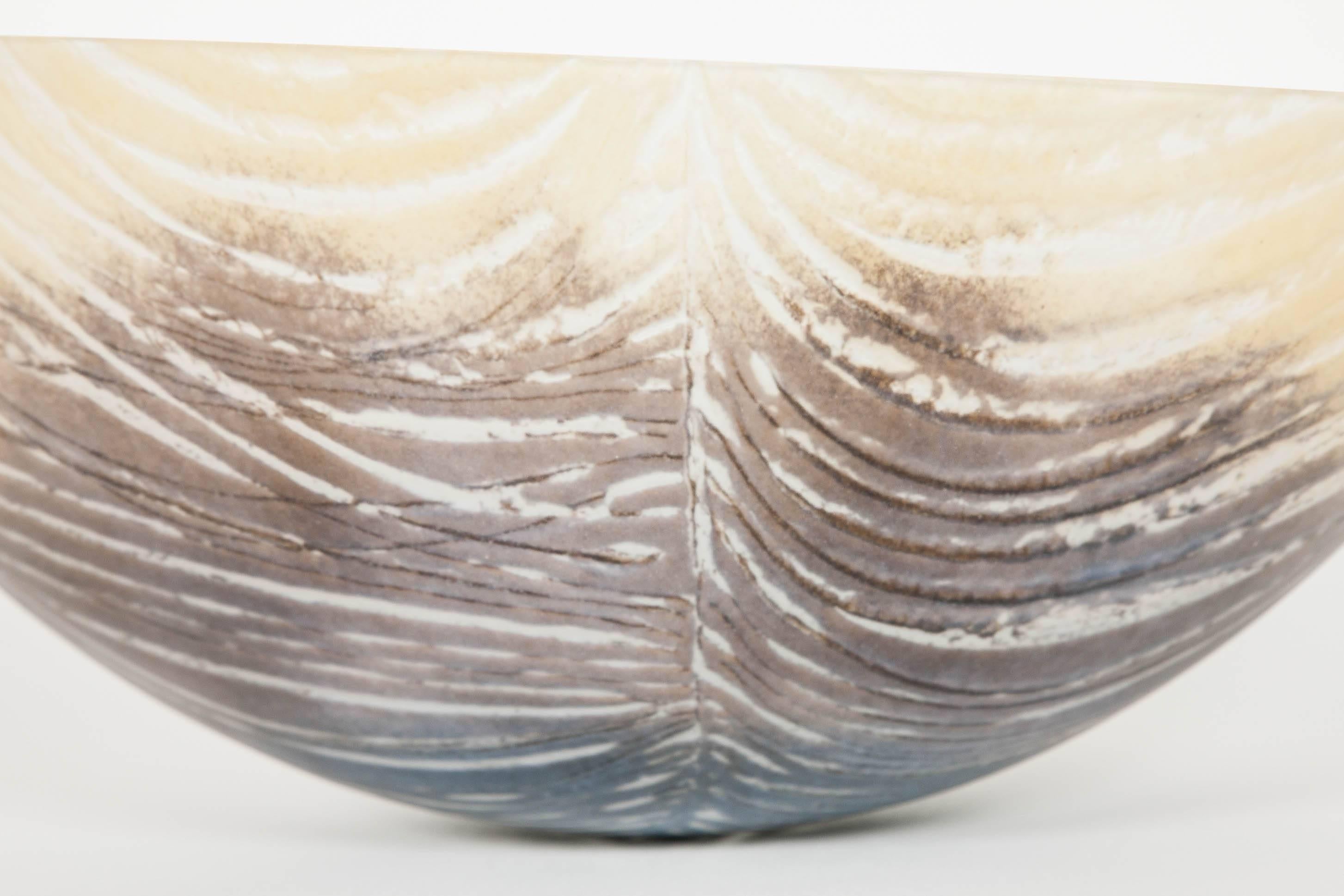 Feather is a unique fused and slumped glass bowl by the British artist Amanda Simmons. Working with the flat sheet glass, Simmons layers powdered colours to create her desired textures, treating the glass more like a canvas to create her imagery.
