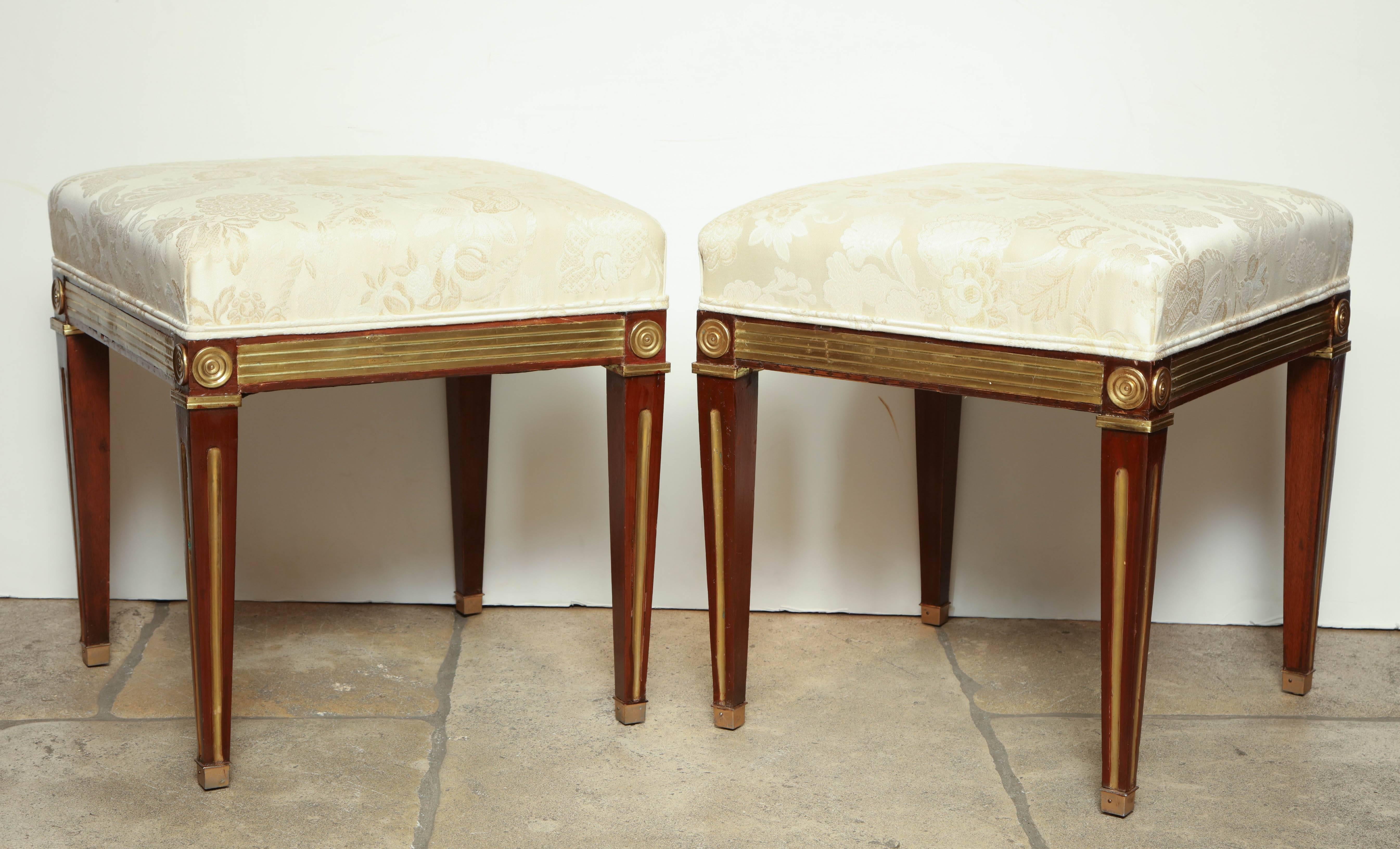A pair of Russian Neoclassic stools with giltwood accents.
