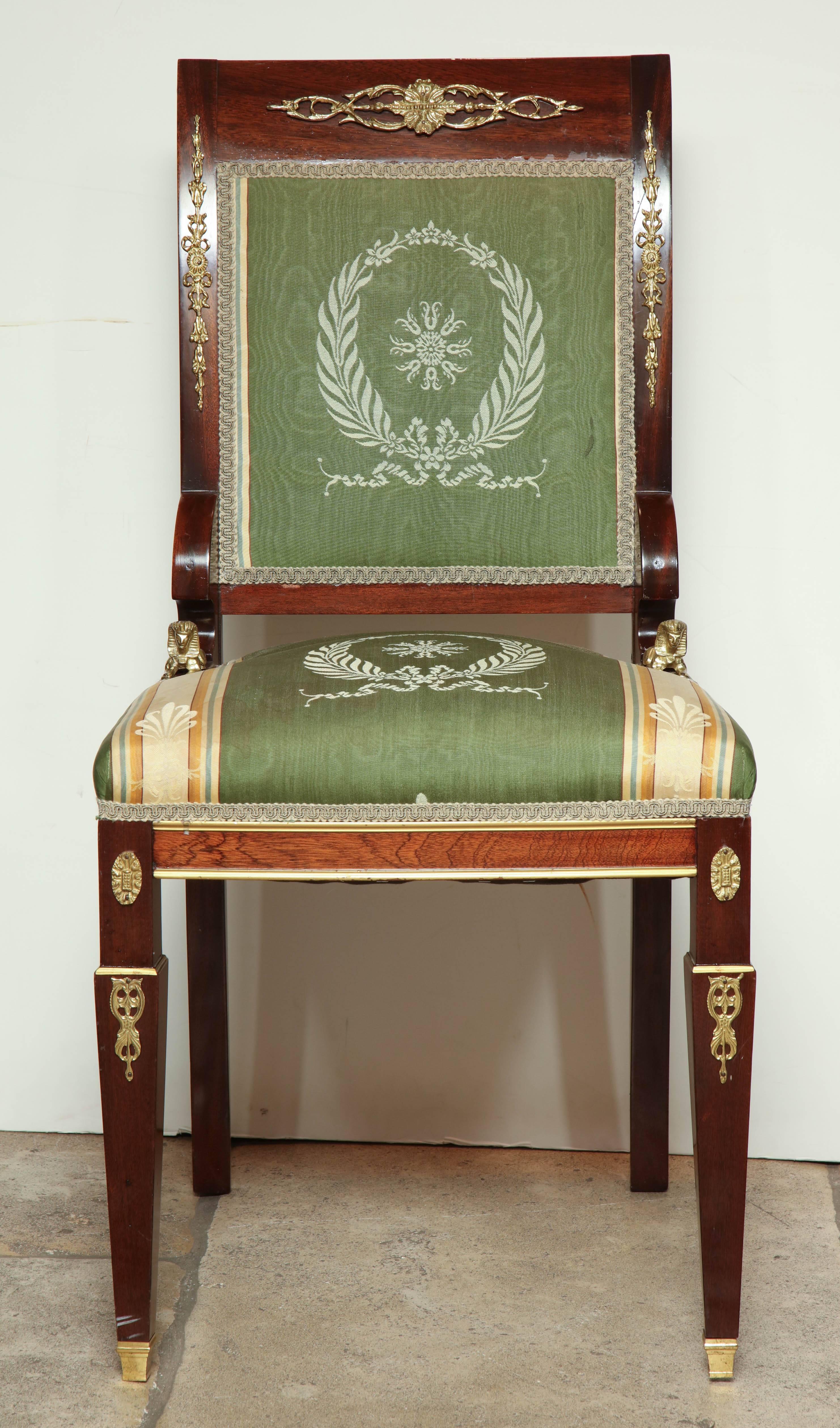 Eight Empire mahogany side chairs with gilt bronze sphinx-form mounts.