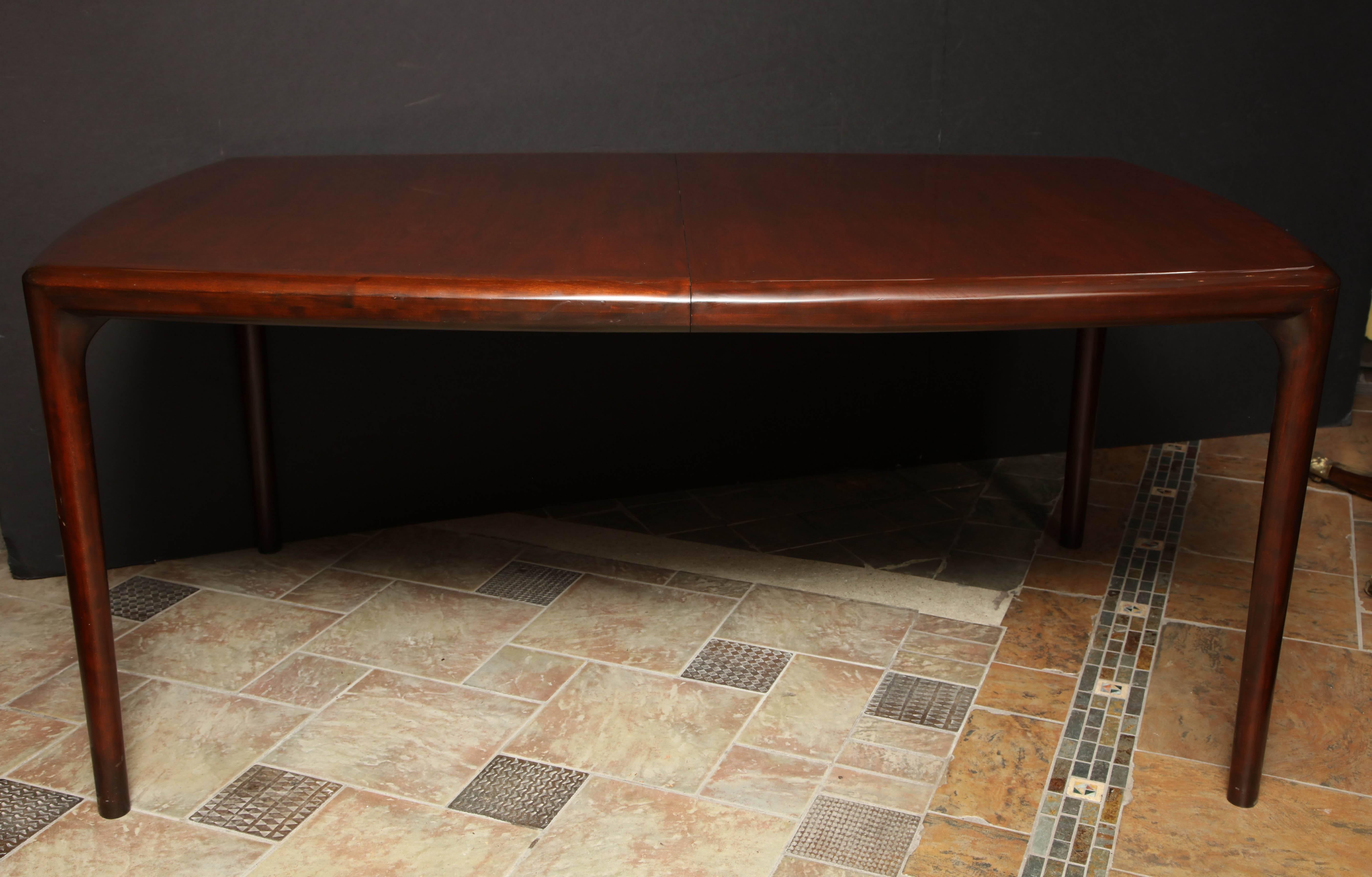 Mid-Century mahogany dining table. Has two 18 inch leaves.