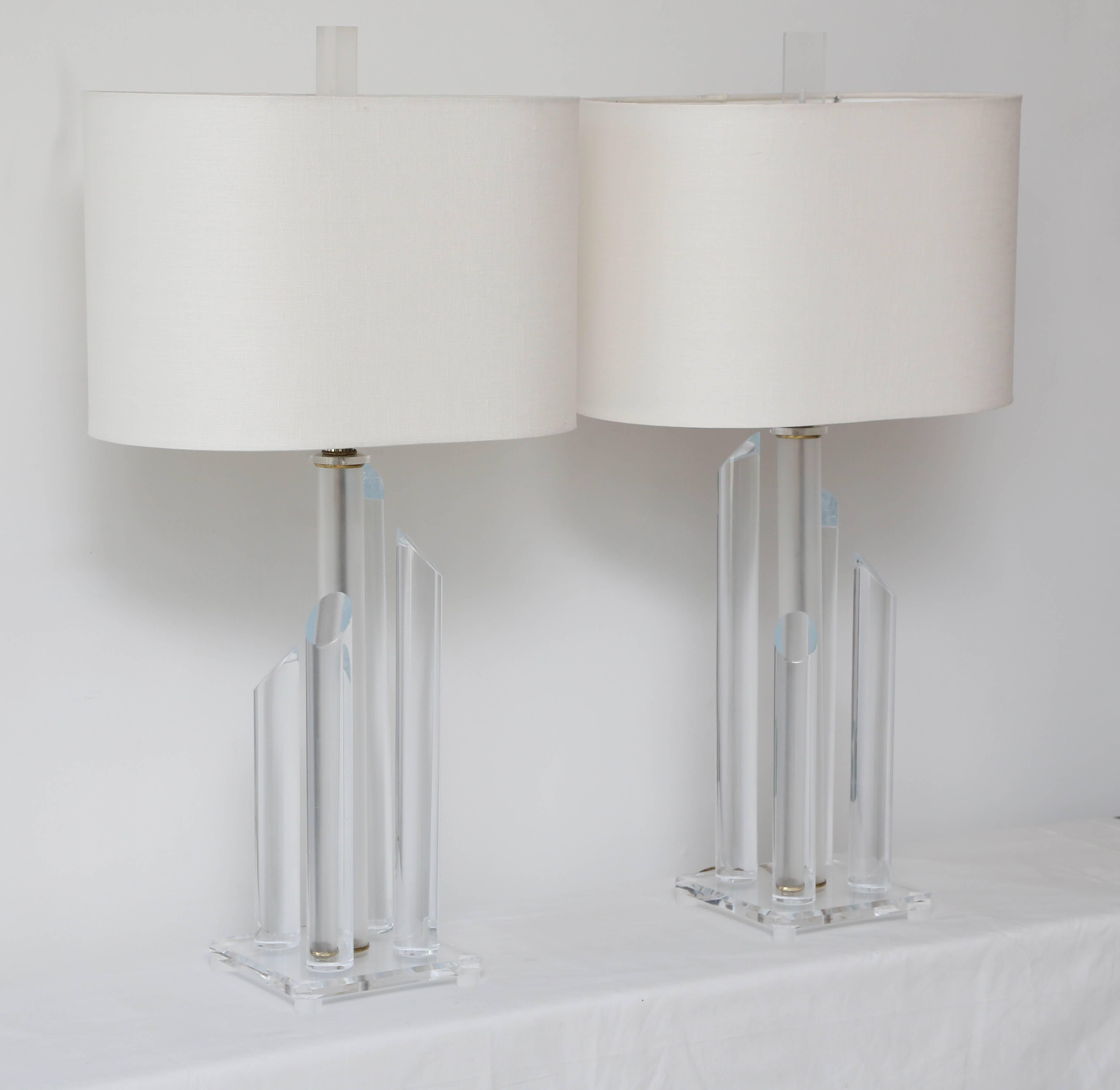 Pair of Mid-Century Modern Lucite lamps with asymmetrical columns and white linen shades.