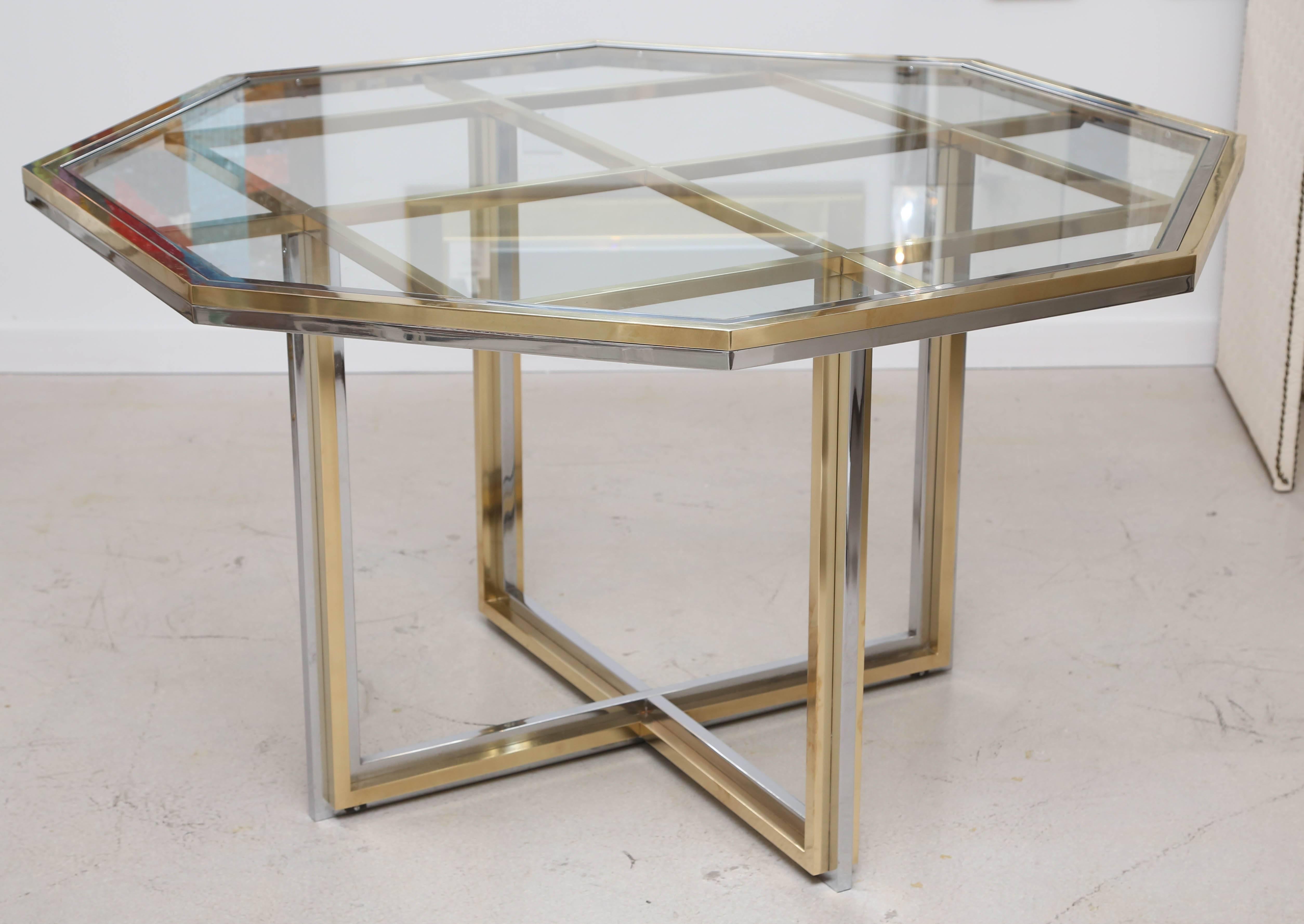 Octagonal mixed metal dining table with glass top by Romeo Rega. The table may also be used as a centre.
Measures: 51 L x 51 W x 29.25 H.