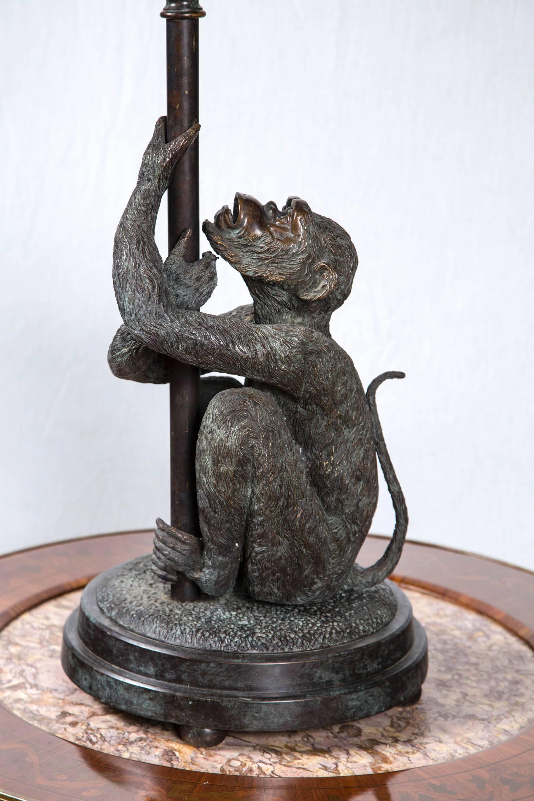 Raised on four half ball feet below circular bases, these naturalistic bronze monkeys are well chased and chiseled with a deep brown/golden patina.
They each have their arms wrapped around a pole as they sit on a rough outcropping. The pole has an