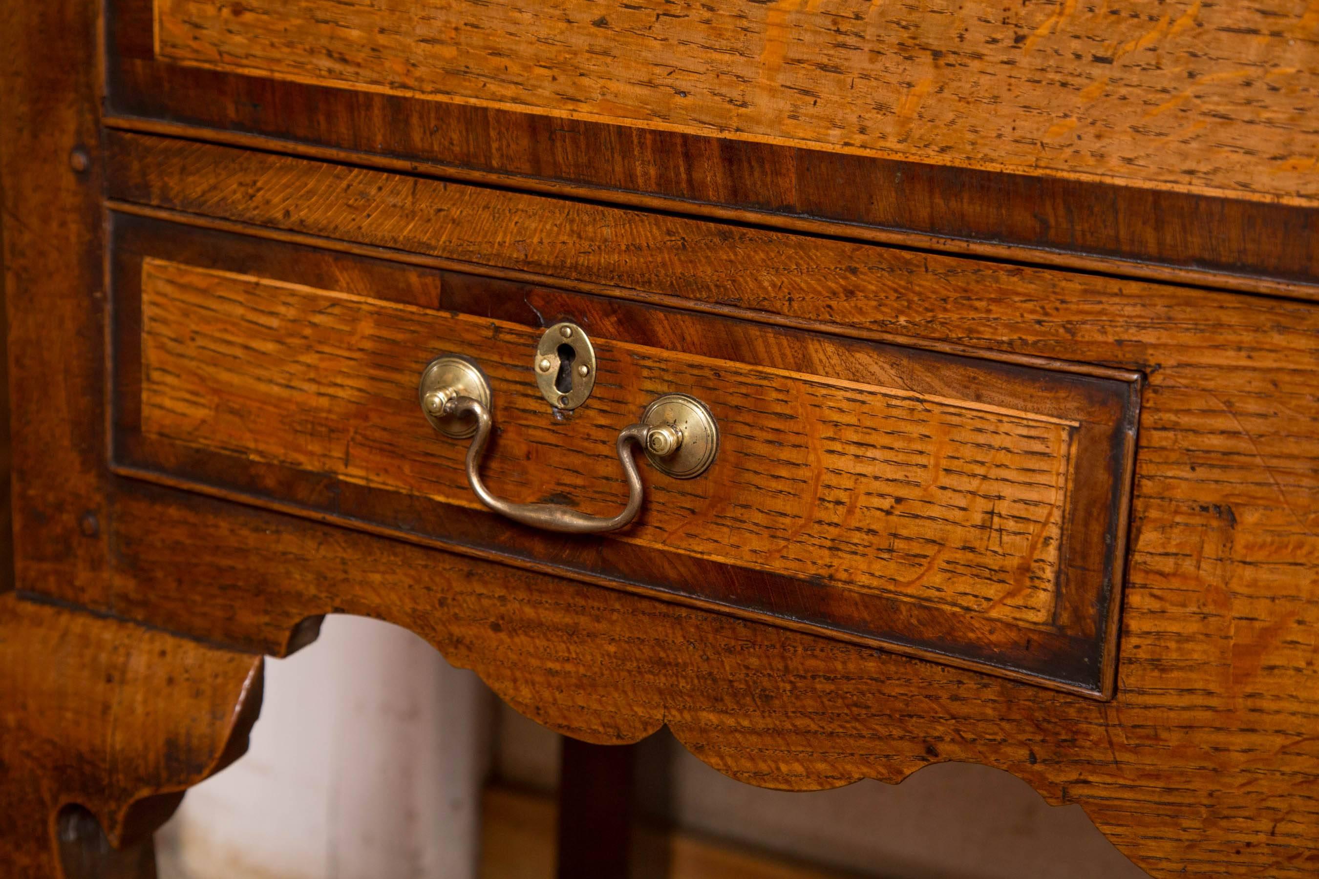 Oak Shropshire server / huntboard with three large upper drawers crossbanded in mahogany over two smaller knife drawers. Shaped apron and stout cabriole legs ending in pad feet. Original brass.