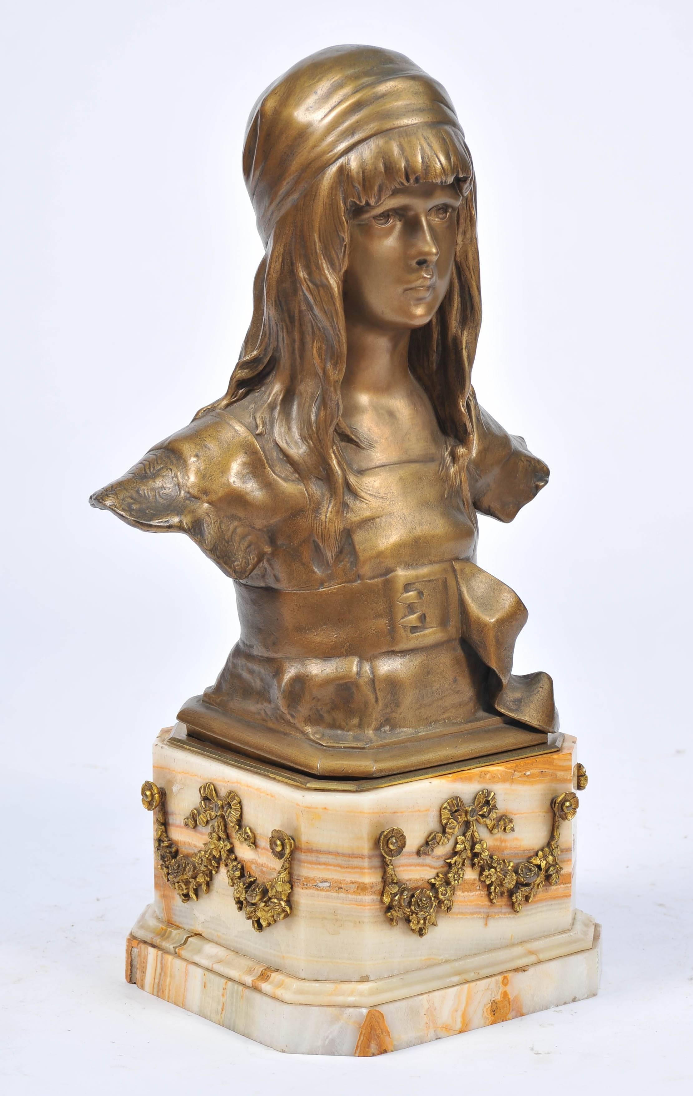 A very good quality 19th century bronze bust of a young girl, mounted on a figured marble plinth with gilded ormolu floral and ribbon swags.
Signed.