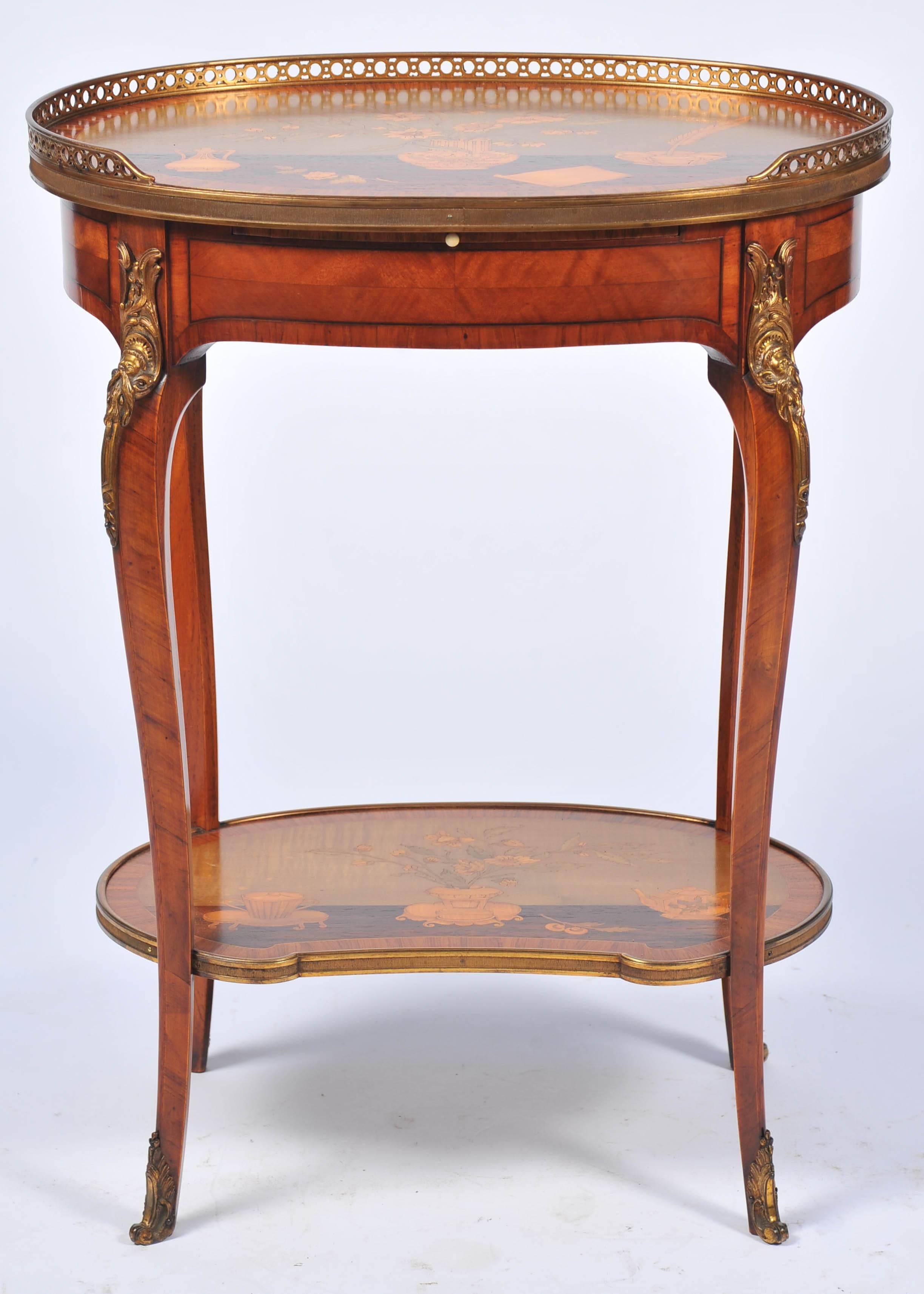 A very good quality French late 19th century Louis XVI style inlaid Kingwood occasional table, in the manner of Topino. Having marquetry inlaid vases, flowers, a quill and paper to the top, a brass gallery around. A slide writing tablet and frieze