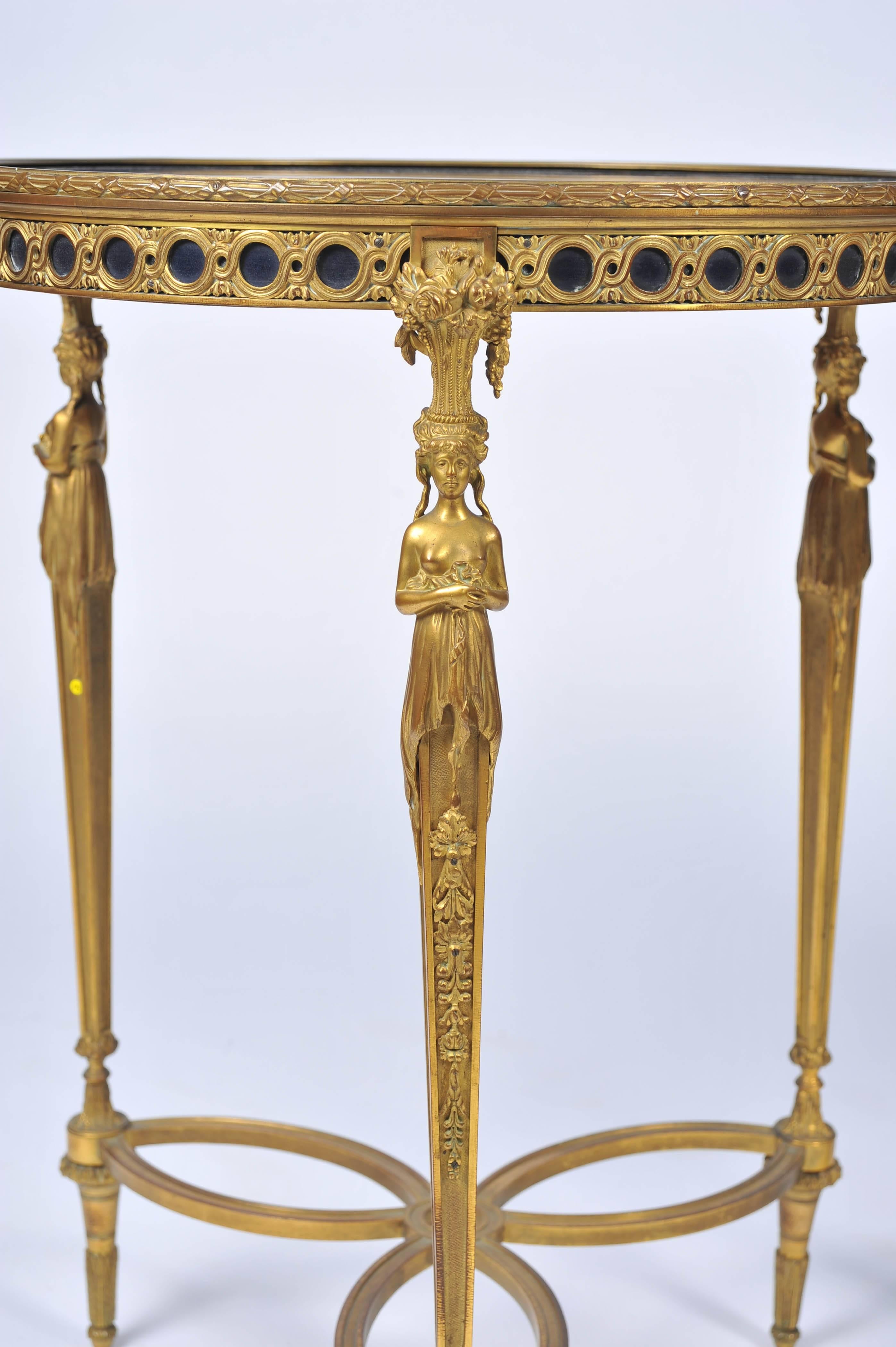 A very good quality pair of French gilded ormolu Louis XVI style occasional tables, in the manner of Adam Weisweiller, having Lapis lazuli tops, three monopodia supports to the lattice work frieze and a stretcher beneath.