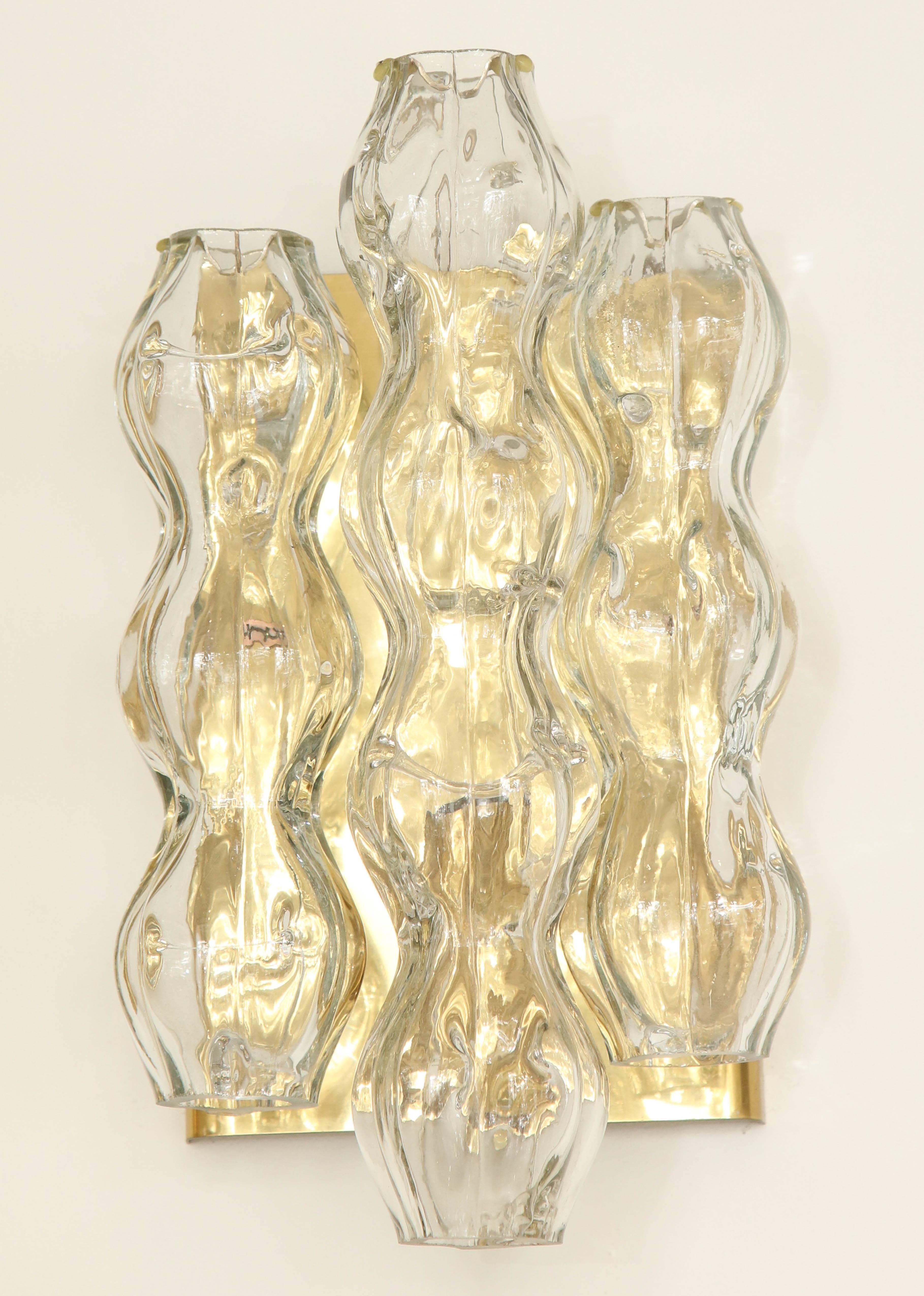 Pair of glass sconces by Doria.
The polished brass plate supports three glass tubes with the centre tube being the longest.
The sconces have been newly rewired for the US.
  