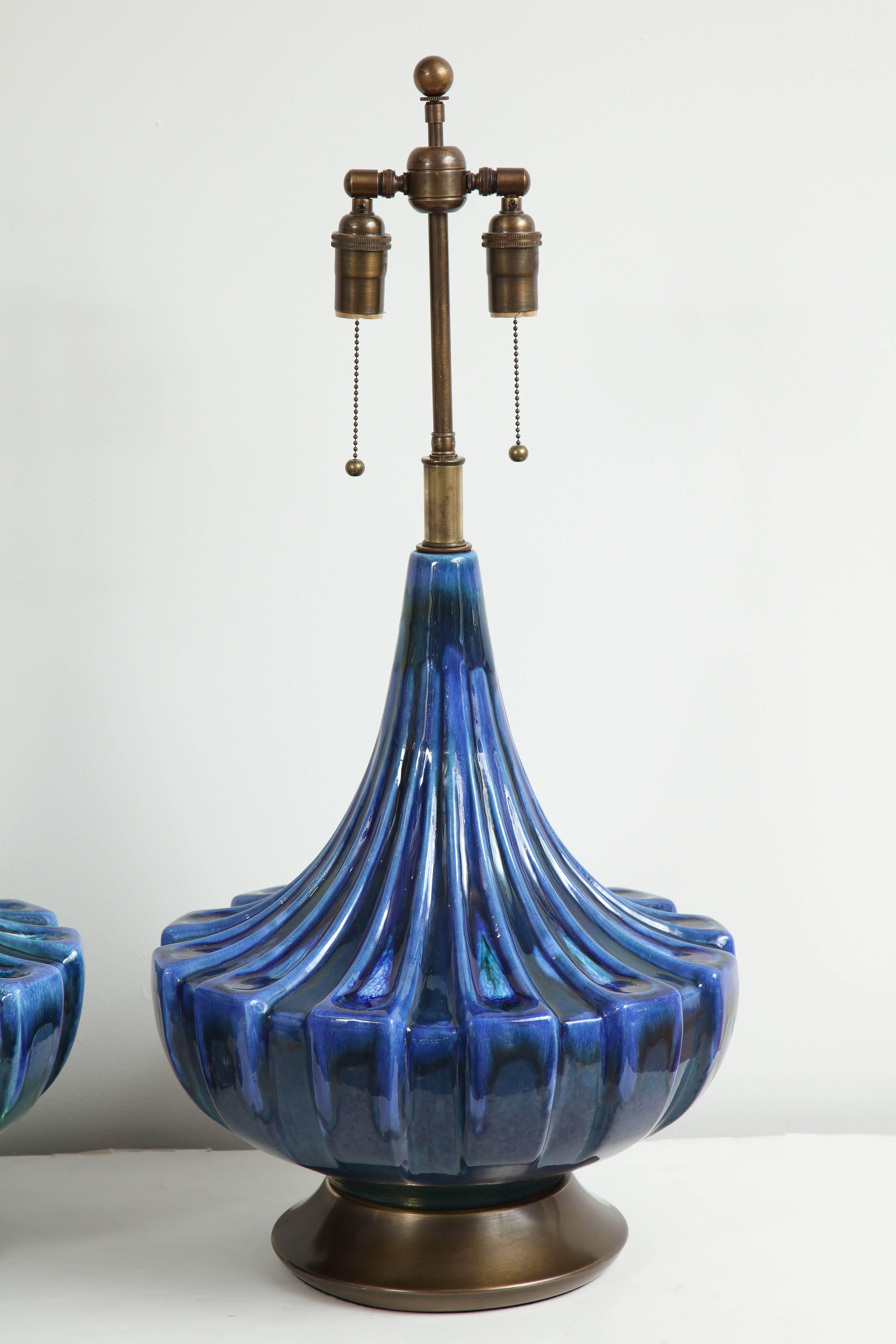 Large pair of ceramic lamps with a beautiful blue drip glaze finish.
The lamps have been Newly rewired for the US with antique bronzed double clusters which take standard light bulbs.