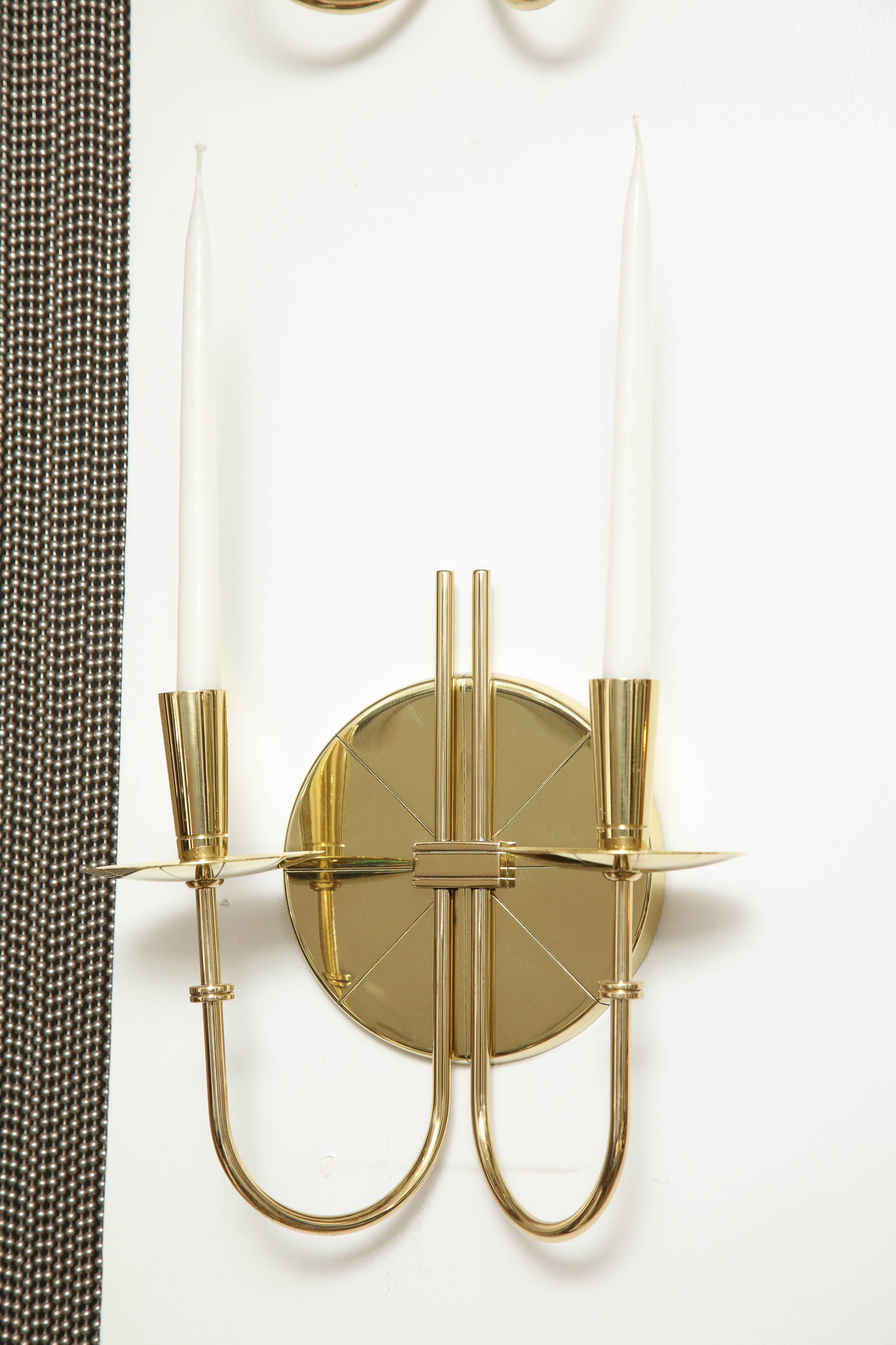 Pair of Mid-Century brass sconces with an etched circular back plate and two graceful arms. 