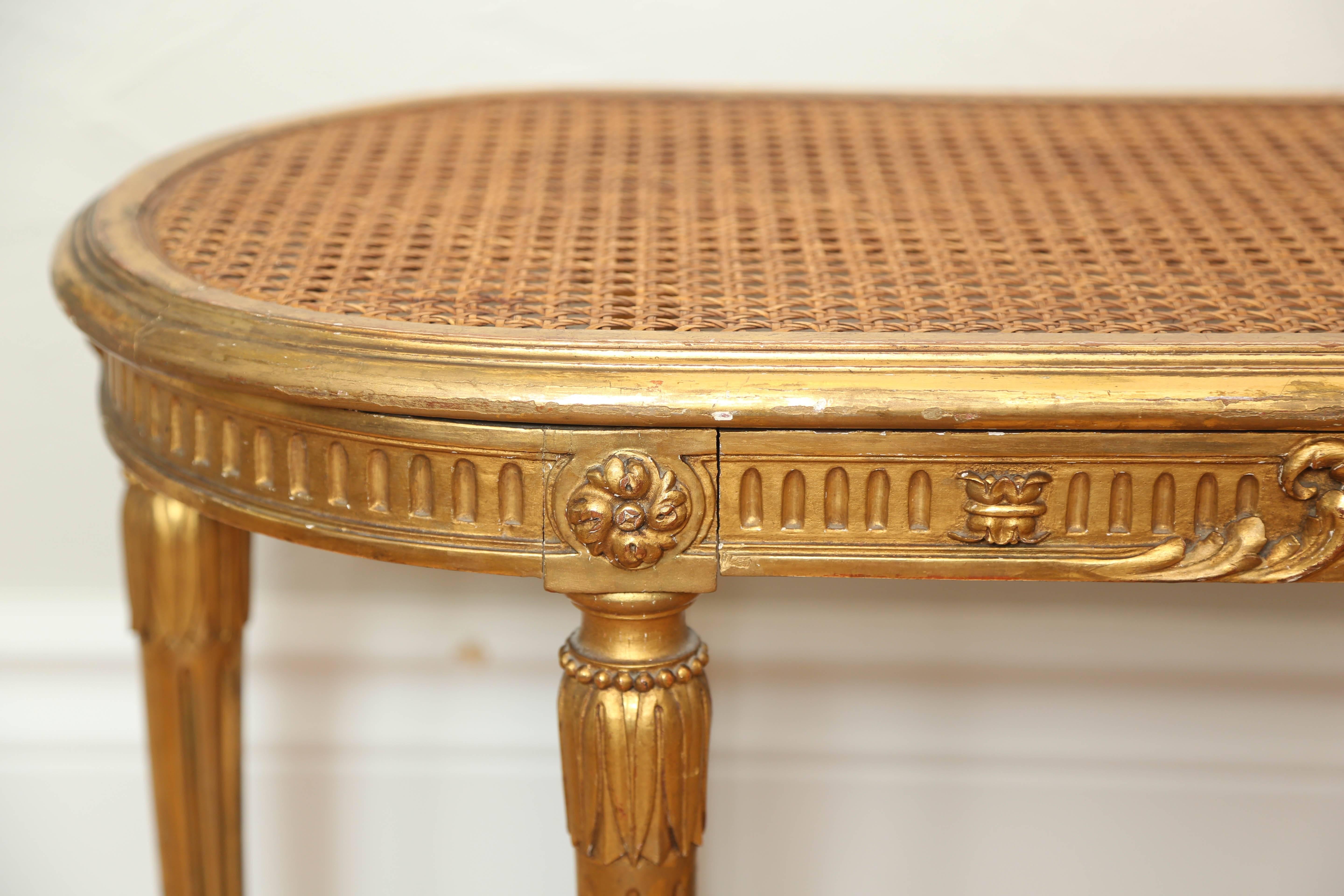 Lovely oval shaped gilded bench with cane seat signed Cullieret.