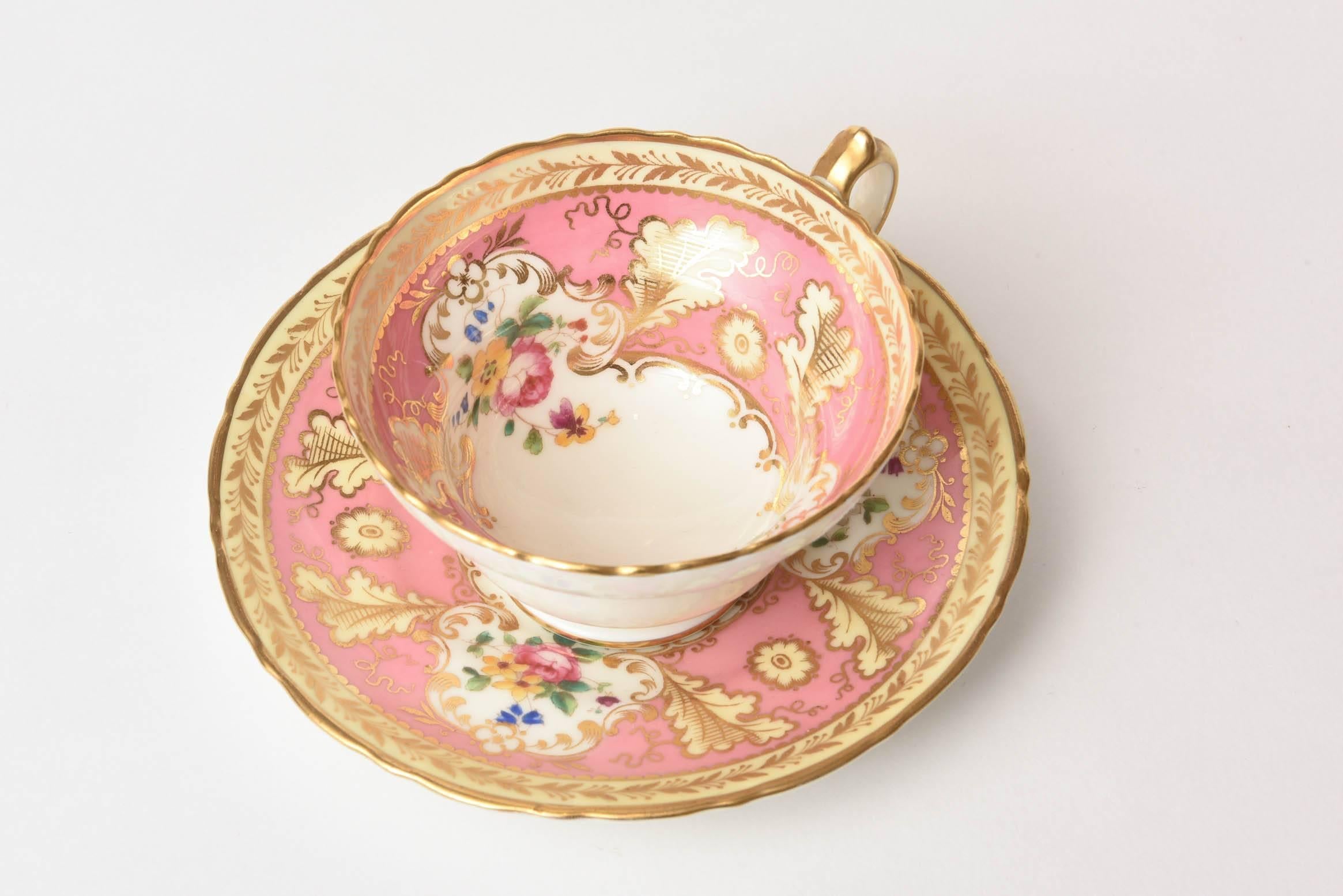 A darling set by Cauldon, England featuring hand-painted floral cartouches in a pretty pink ground and trimmed with gold. This set also has a sweet ear shaped handle and slight pedestal base. We have 10 sets total if you would like and this listing