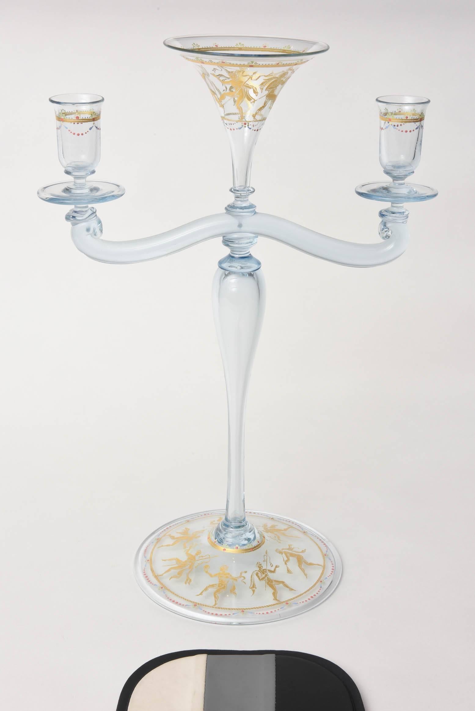 A tall and decorative candelabra from the artisans in Venice. This one features figural dancers and raised enamel bead swag. A pretty light blue in color and please see the matching centre bowl and goblets. Original family documents show sales