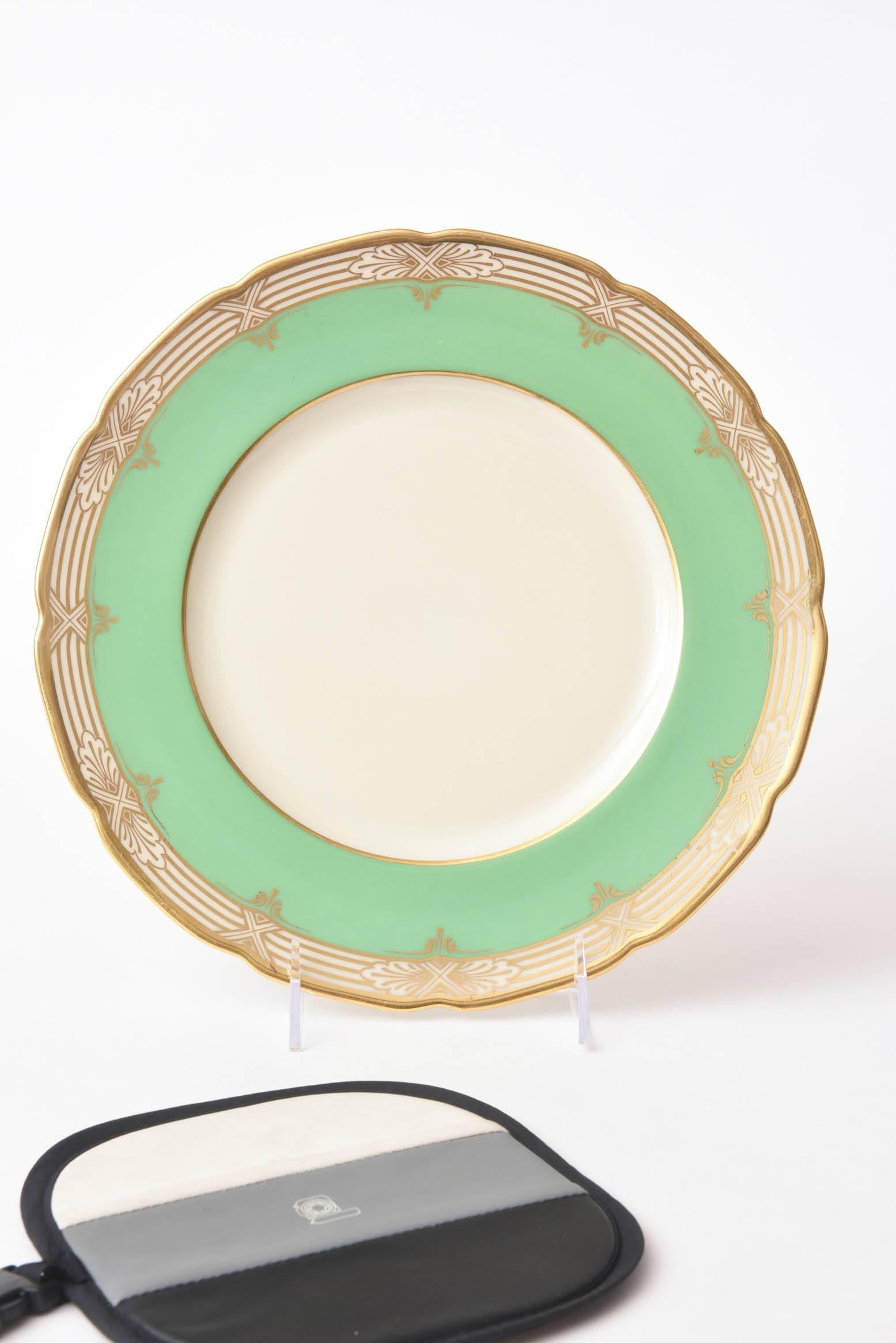 A perfect shade of green and gilt dinner plates to mix and match in for your table. A gently scalloped shape with multiple bands of gold and nice clear centres. Custom ordered through the fine retailer of Marshall Fields, Chicago and made by Lenox.