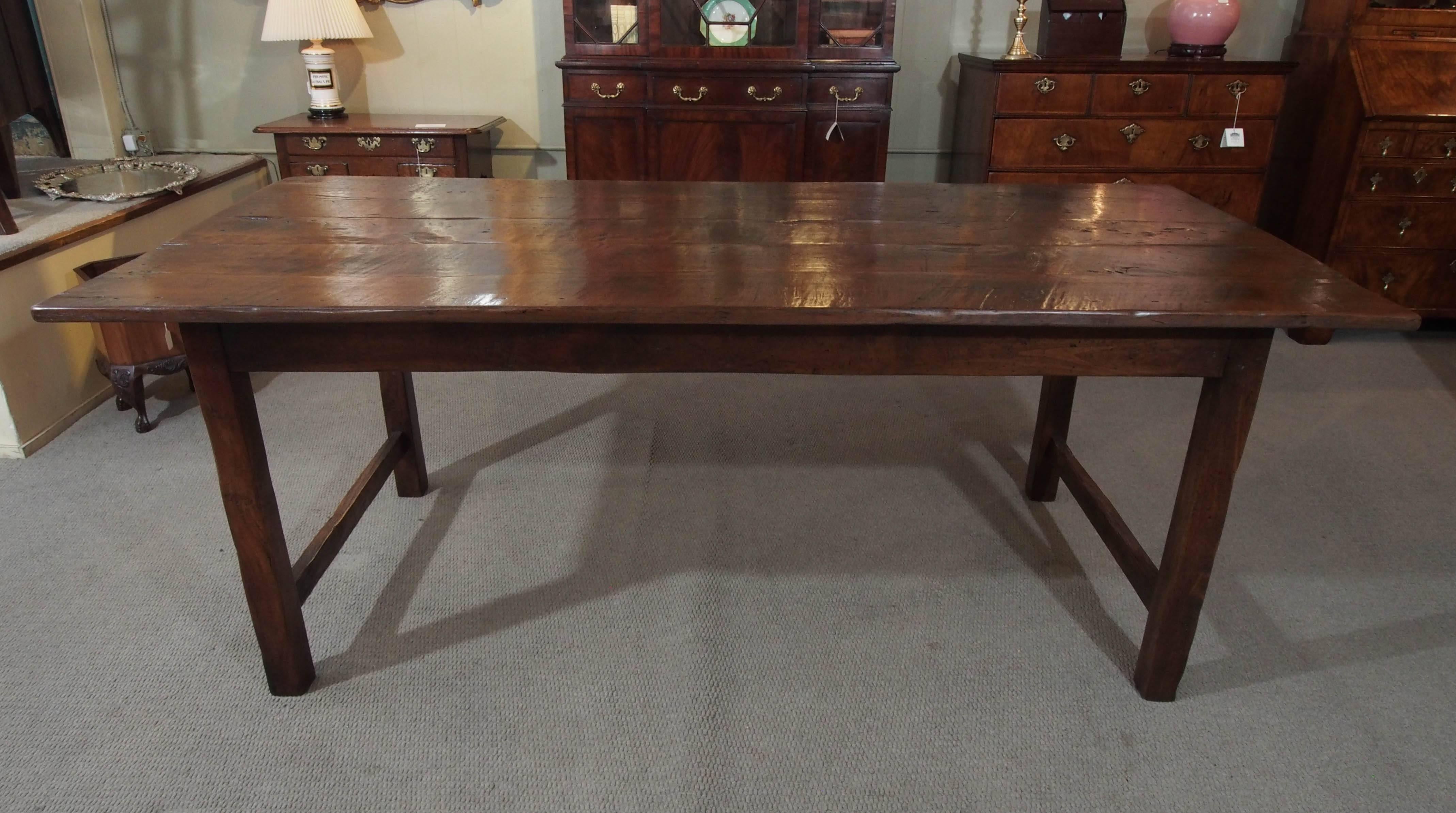 Antique French Provincial chestnut farm table with end stretchers. Fine patina.