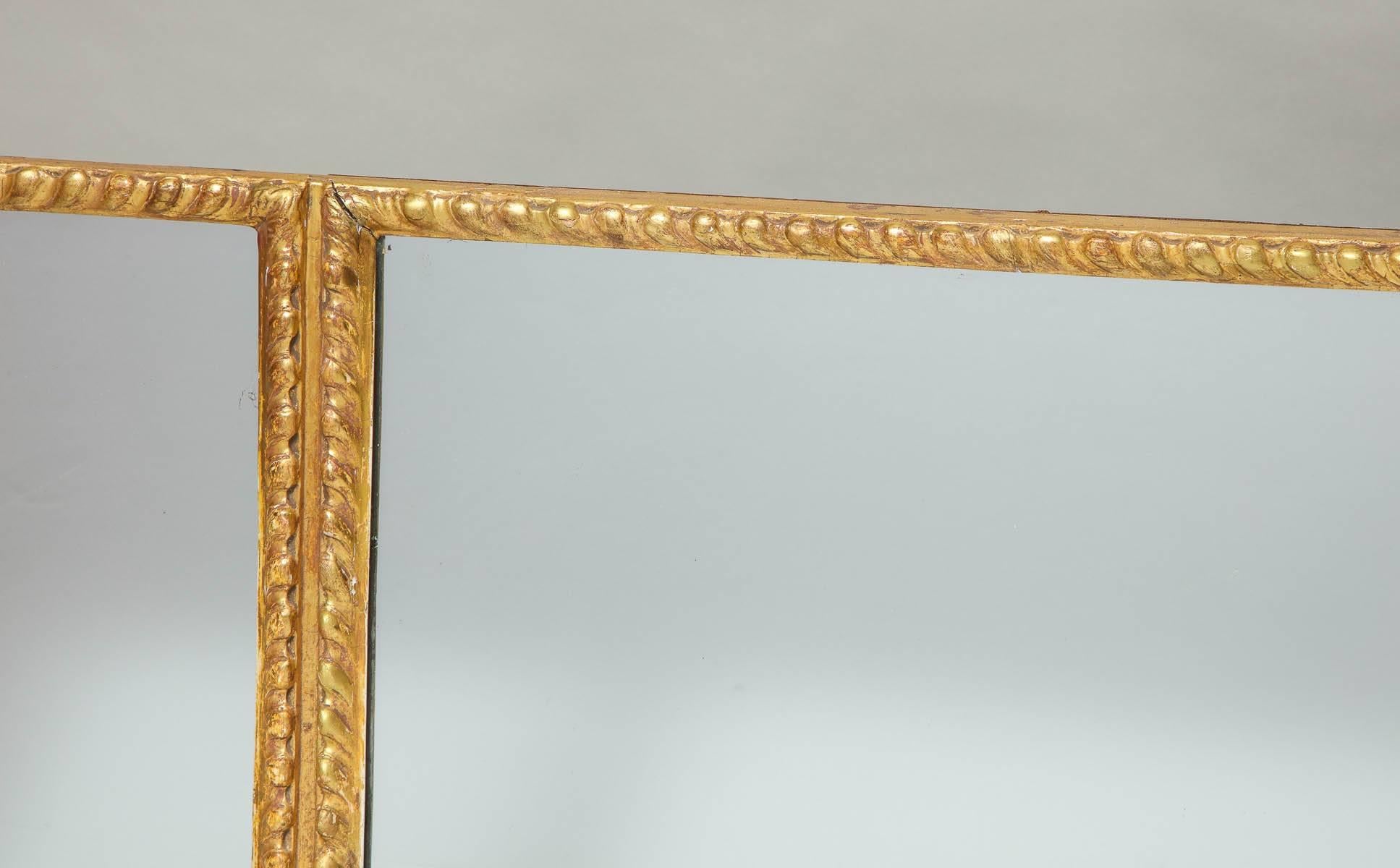 Very good George III three-plate giltwood overmantel or landscape mirror, having richly gadroon carved frame and richly burnished water gilt surface.