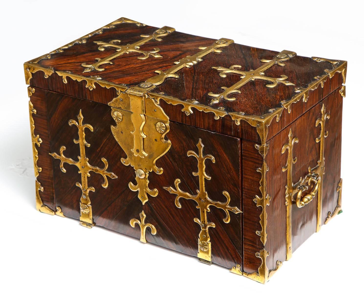 Late 17th century rosewood strong box. 
The interior cut shaped and shanferred, gilt brass strap work. The interior with both visible and secret compartment to hide gold and diamonds. Internal crank screws. Superb color, very rare and decorative!