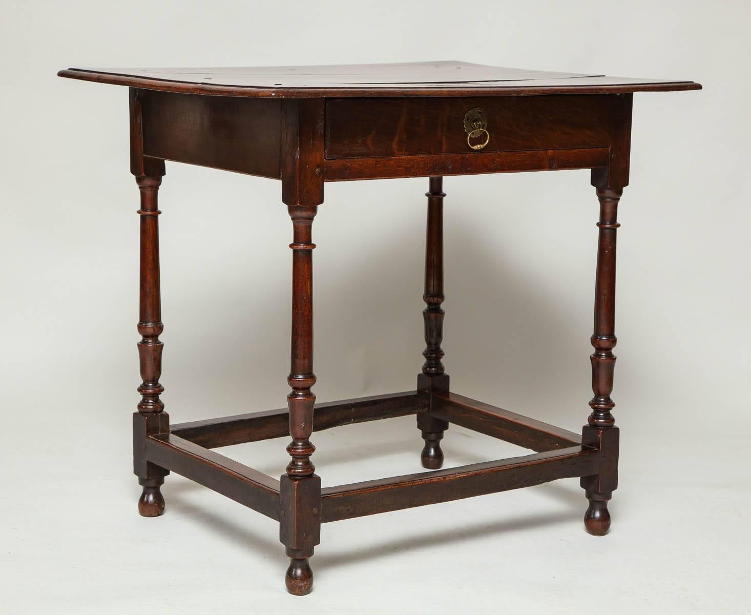 Good English country oak and fruitwood side table, the thumb molded top over vase and ring turned legs, single drawer with central pull, joined by molded box stretcher and standing proud on original egg feet, the whole with excellent color.