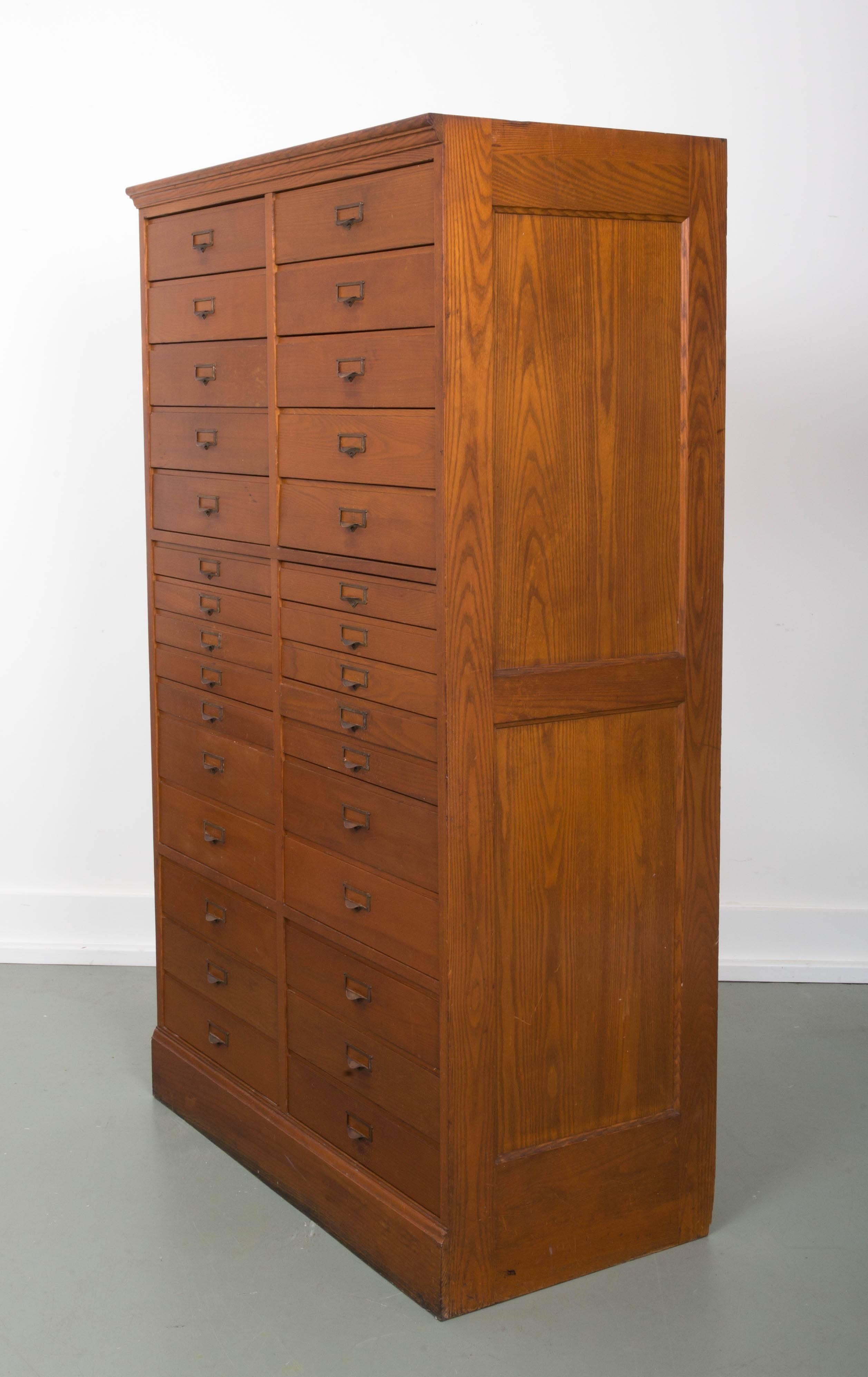 A wonderful 30-drawer architect cabinet for storage; original finish. The inside height of the top ten drawers measures is 3 1/4 inch 3 with holes. The next ten drawers measures are 1 1/2 inch height inside all with holes, and the bottom ten drawers