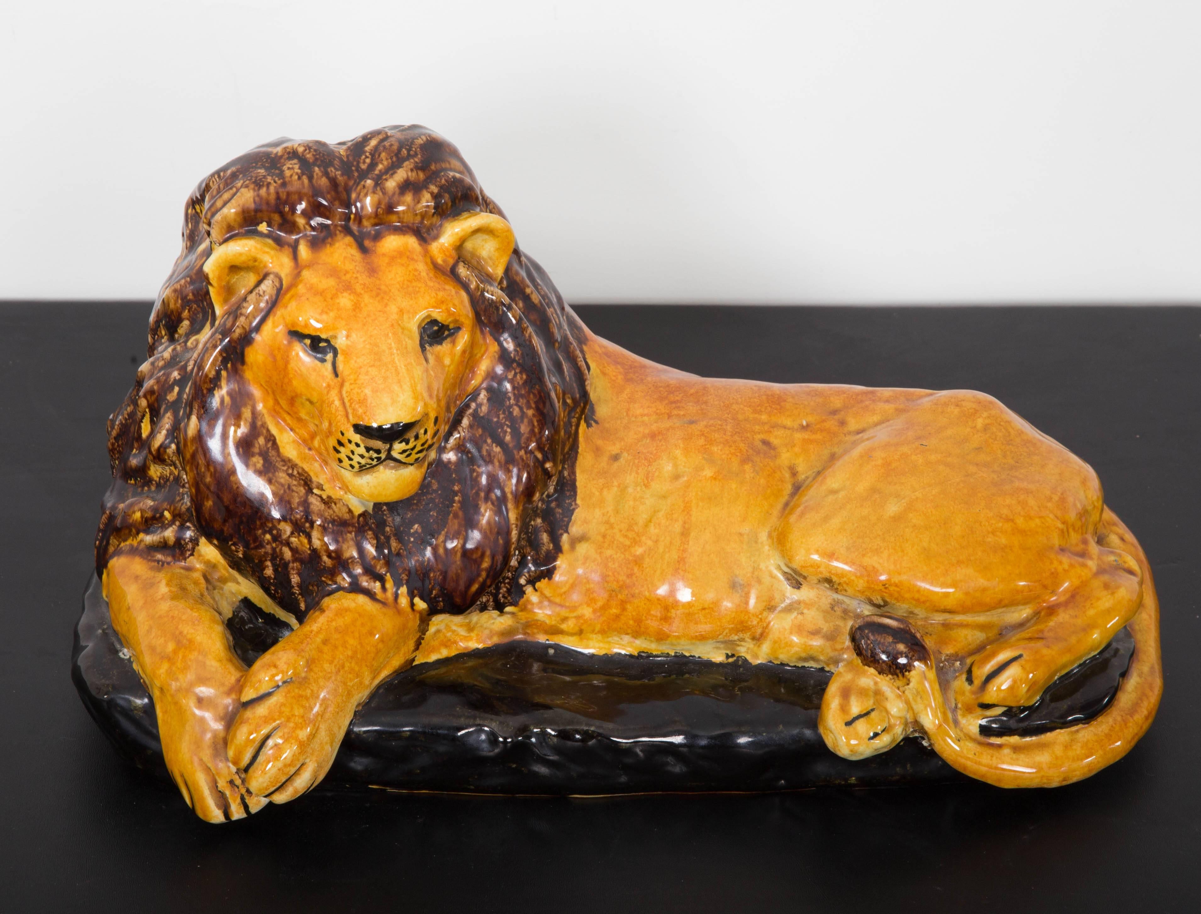 Handmade Italian glazed terracotta reclining lion.