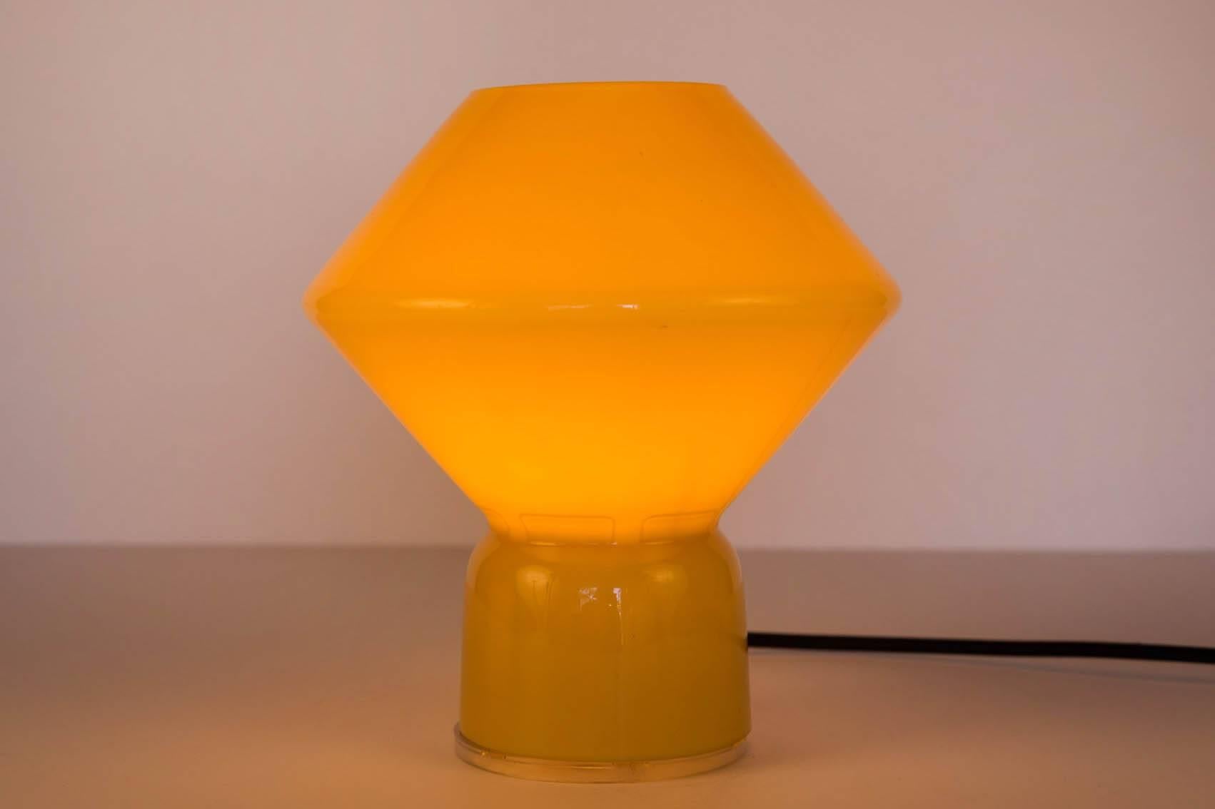 1980s Memphis style 'Conica' table lamp for Artemide. Designed by Alessandro Mendini. Original manufacturer's stamp impressed on base. Handcrafted in Murano amber glass, this petite lamp is strongly associated with the 1980s Memphis style that came