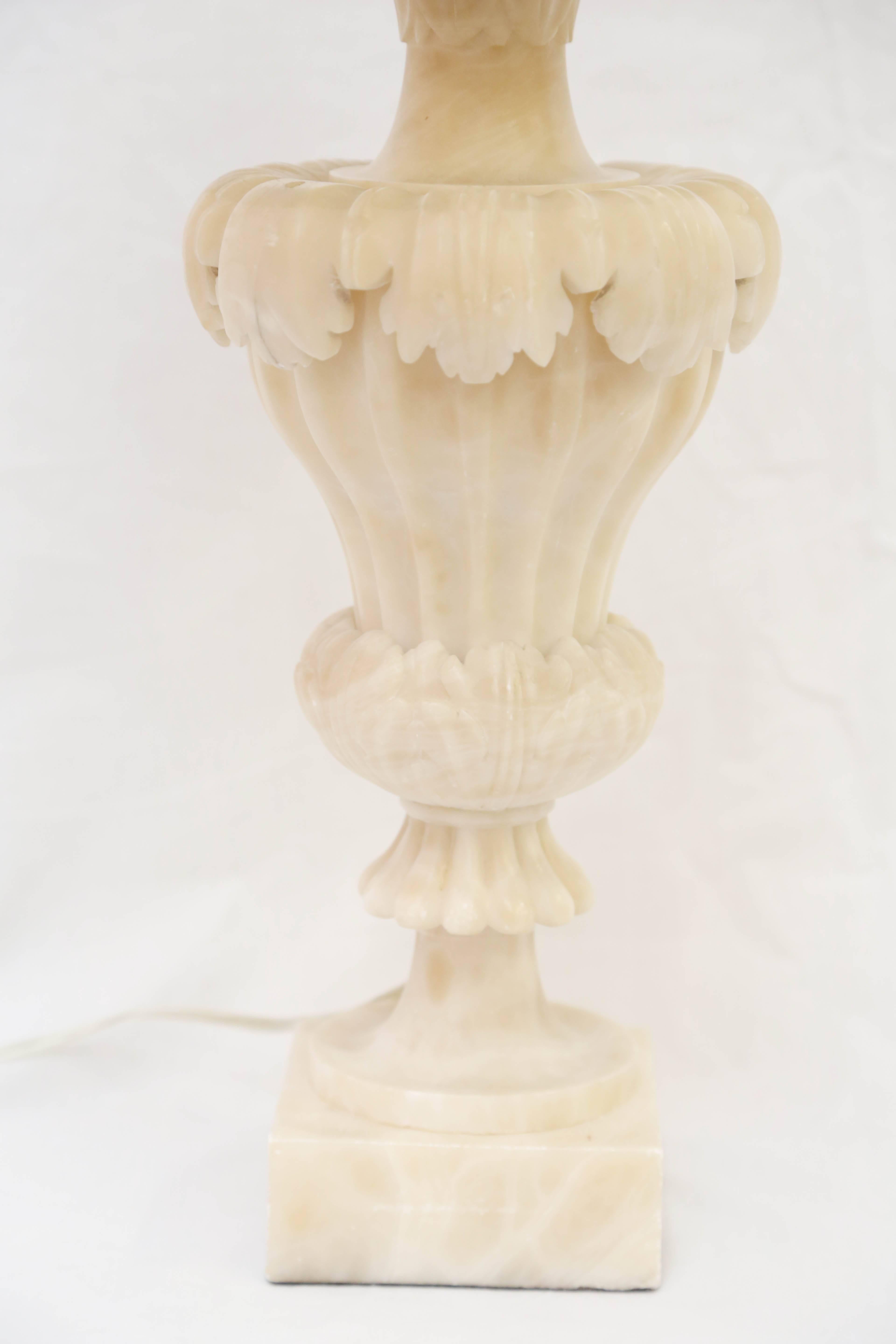 Each of vase form boldly carved with acanthus leaves on a plinth base. Measures: Height to socket: 21.5".
