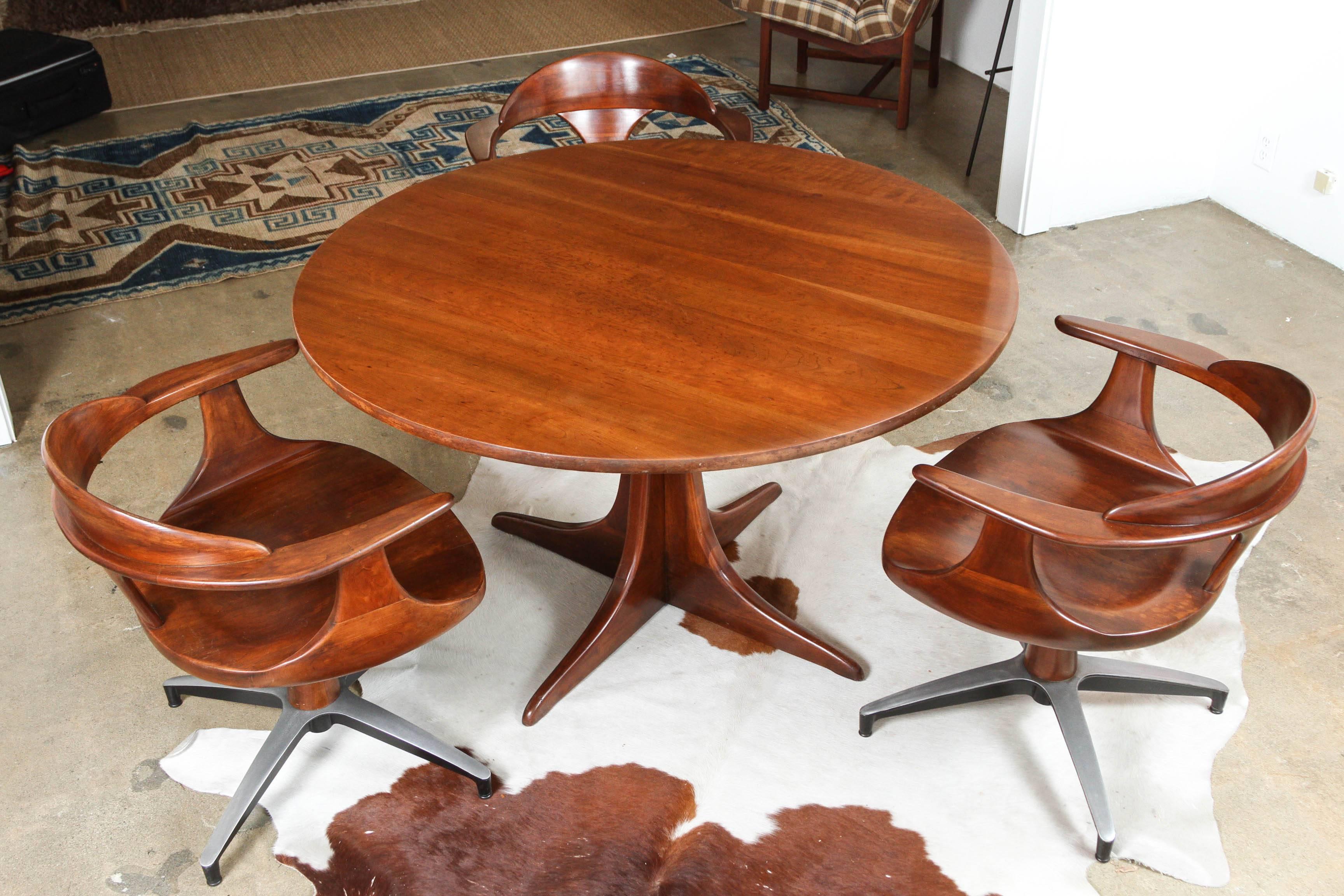 A rare Heywood Wakefield Cliff House mahogany table set - four swivel armchairs with metal base; beautiful joinery and details.


