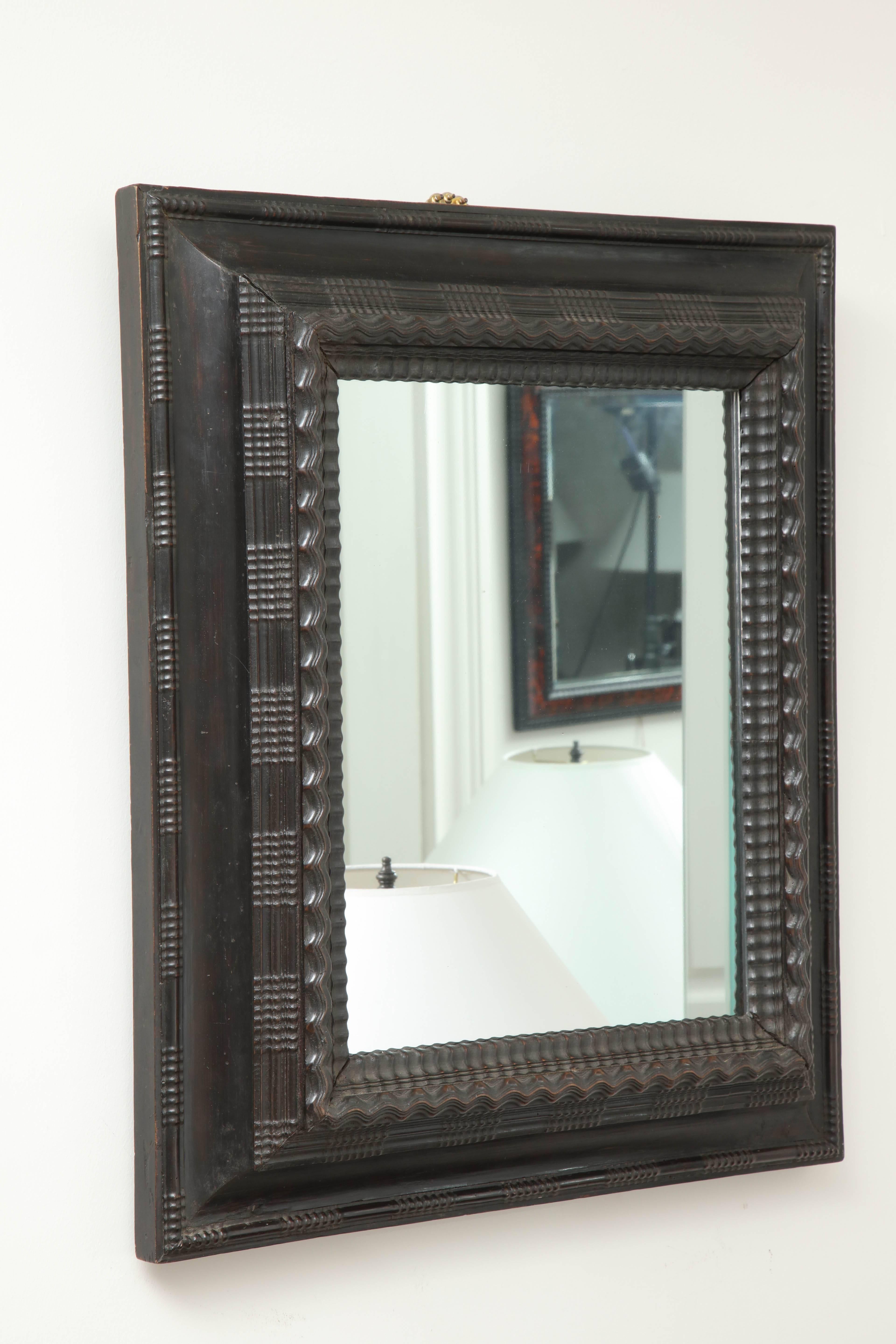 Late 19th century ebonized mirror, molded and stepped borders.