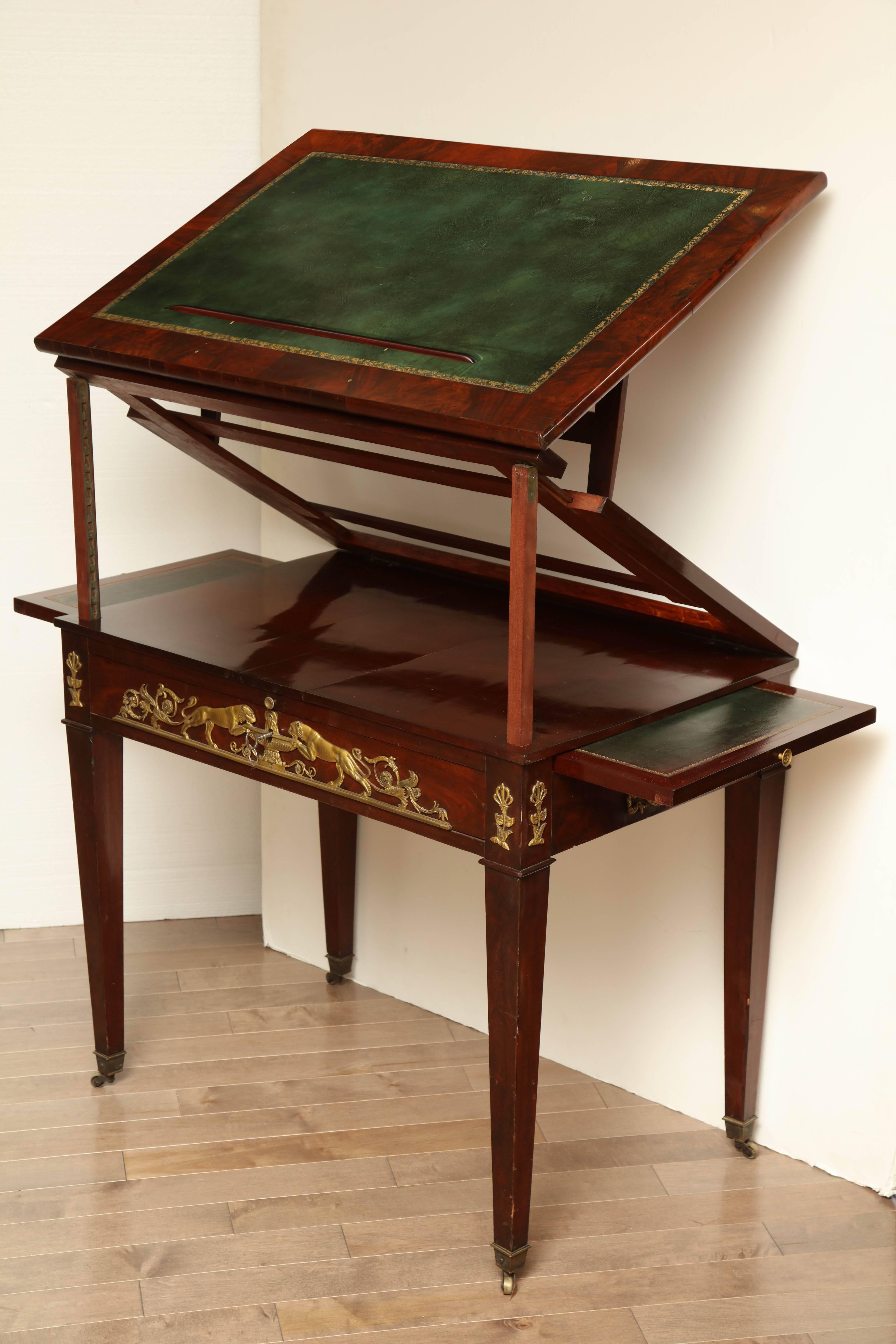 Early 19th century, French Empire, mahogany architects desk with ormolu mounts and leather top.


    