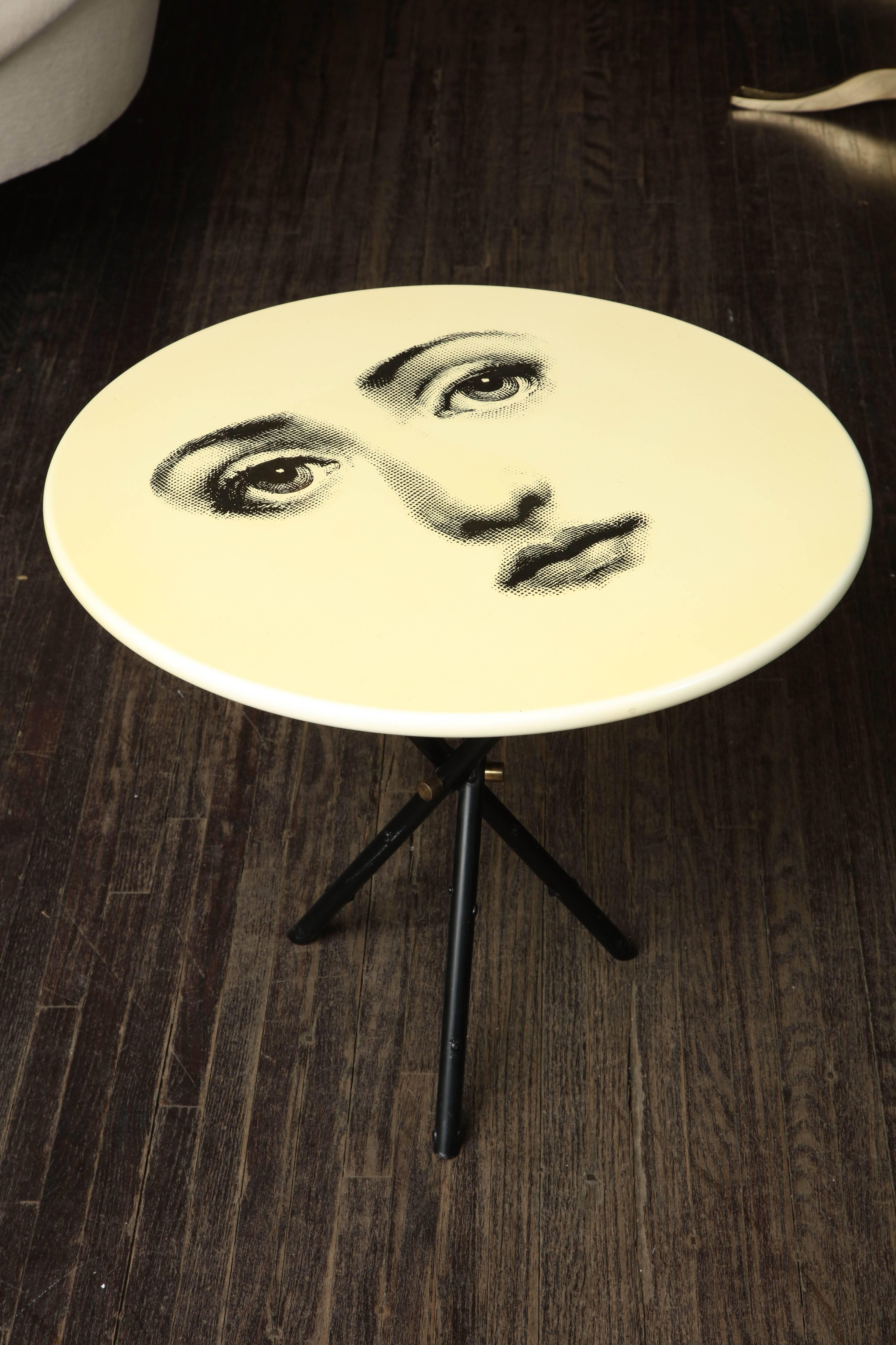 Vintage Fornasetti side table with iconic face and original label.