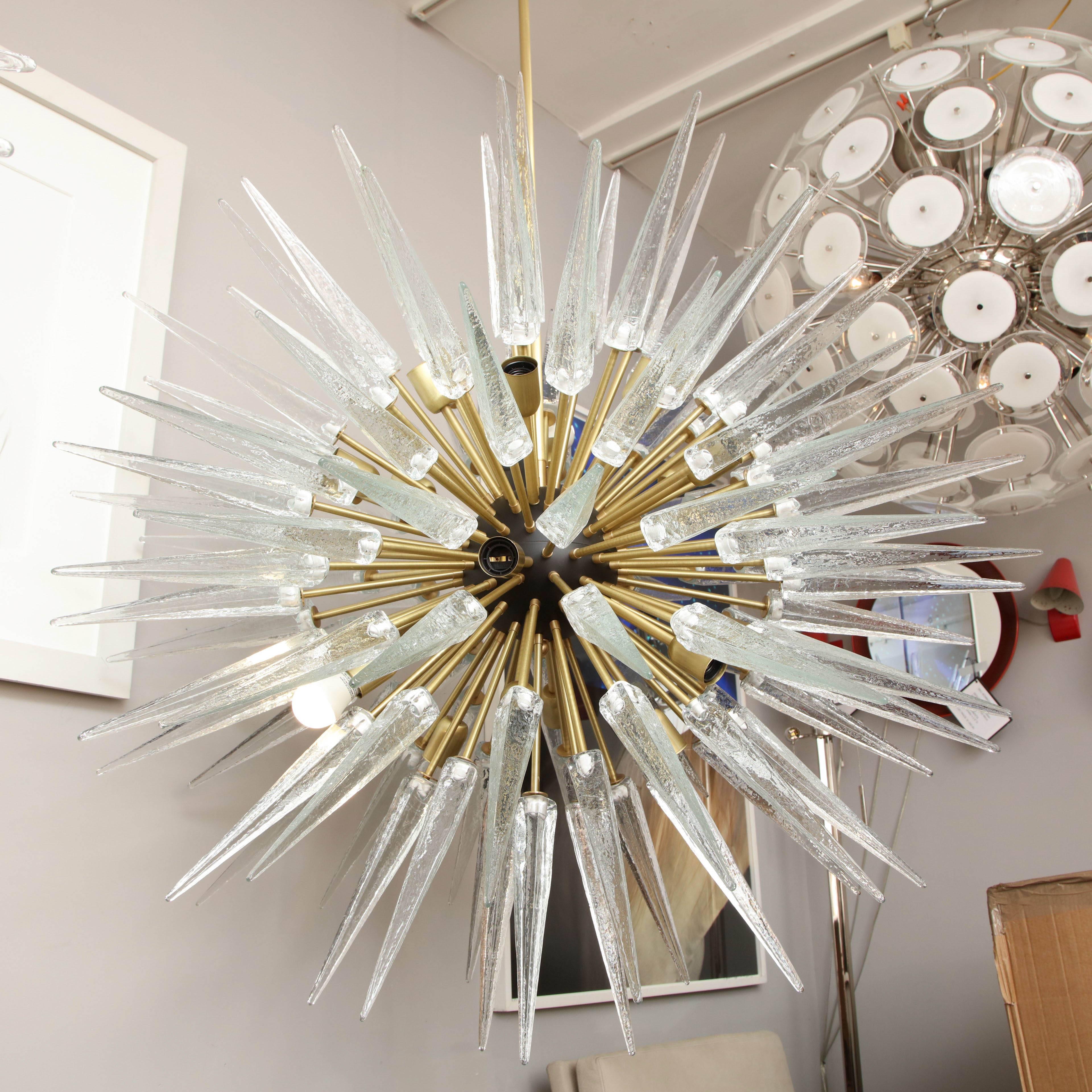 Stunning Murano glass spike sputnik chandelier in clear glass and satin brass arms with ebony black sphere available for custom order.