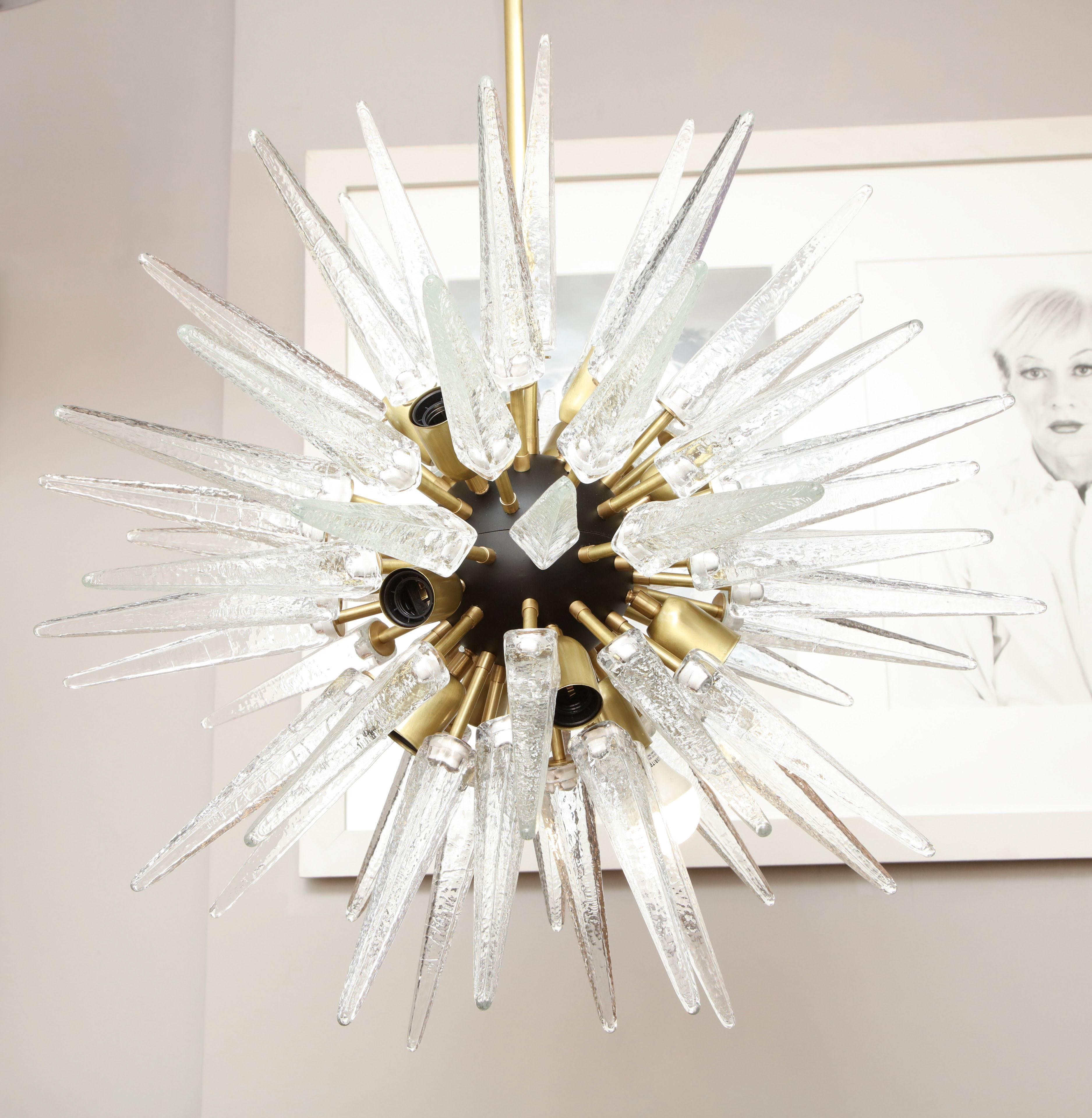 Stunning Murano glass spike Sputnik chandelier in clear glass and satin brass arms with ebony black sphere.