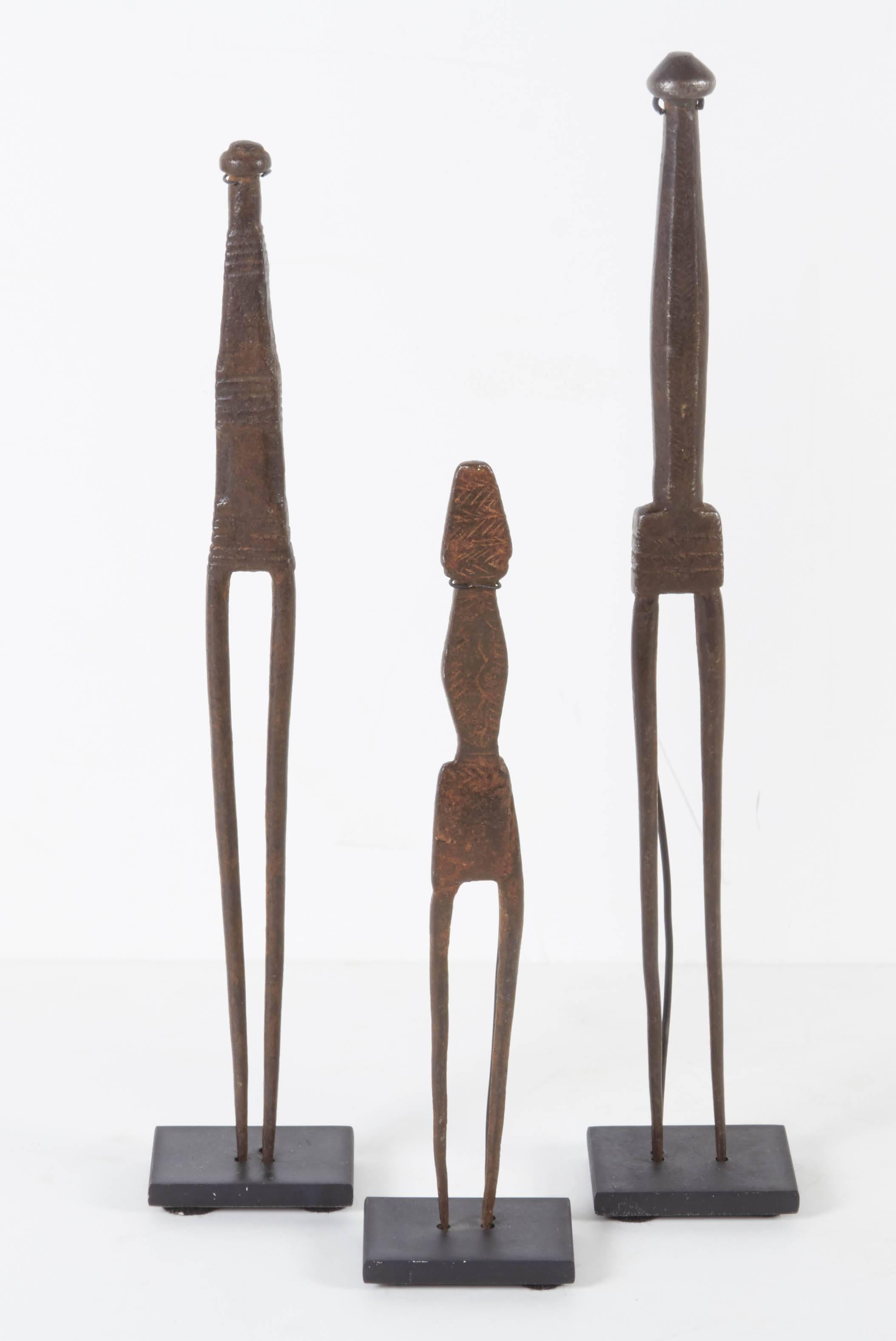 A set of three carefully hand-forged antique hair picks on custom stands. These uncannily anthropomorphic objects are from Nagaland in the North of India. This set of antique objects could be easily mistaken for contemporary sculpture.
M933.