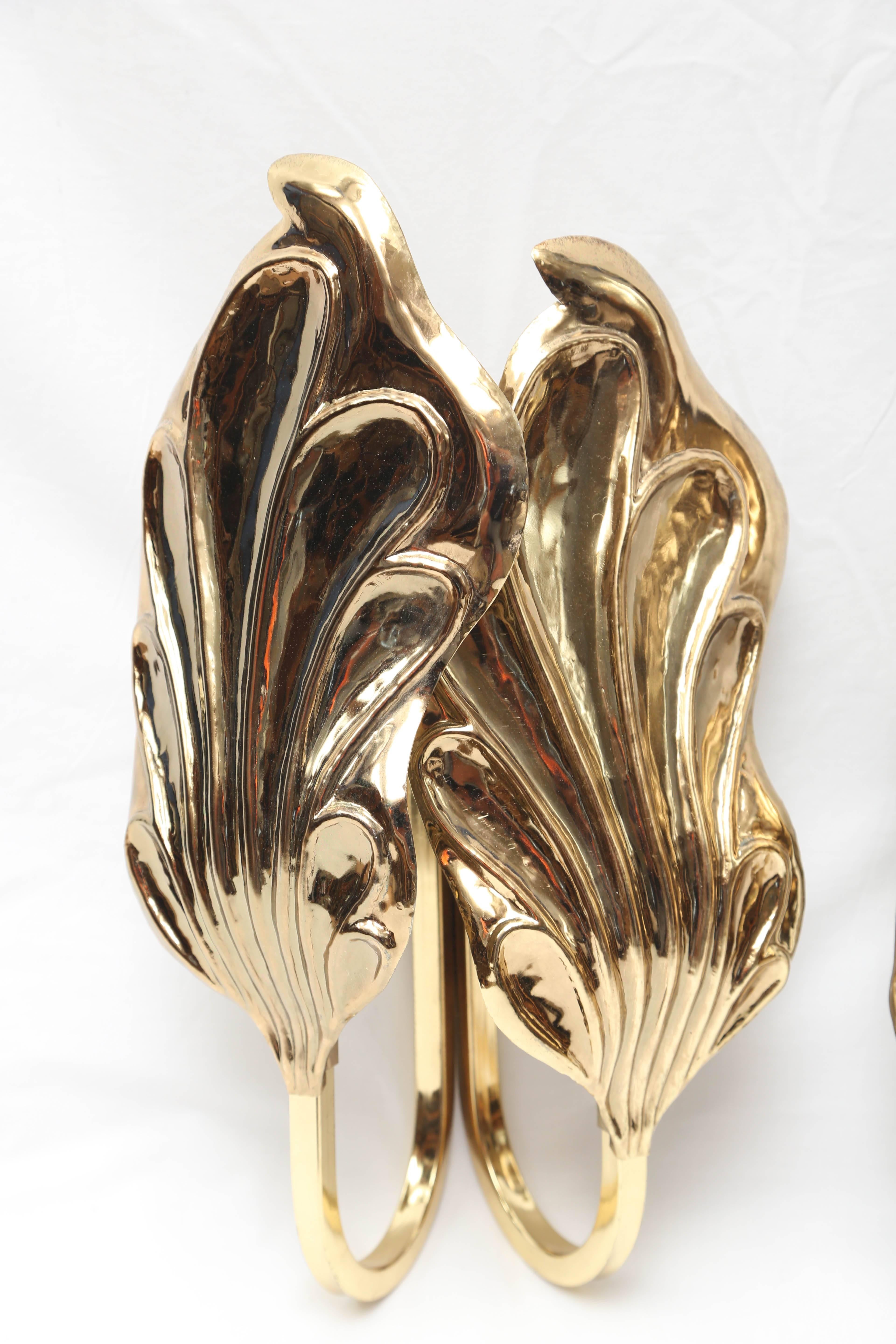 Gorgeous pair of vintage Tommaso Barbi brass Italian leaf sconces, circa 1970s. These Classic sconces are in excellent condition, matched left and right, and have two candelabra lights in each sconce. Each sconce measures 17” H x 9” W x 6” D.