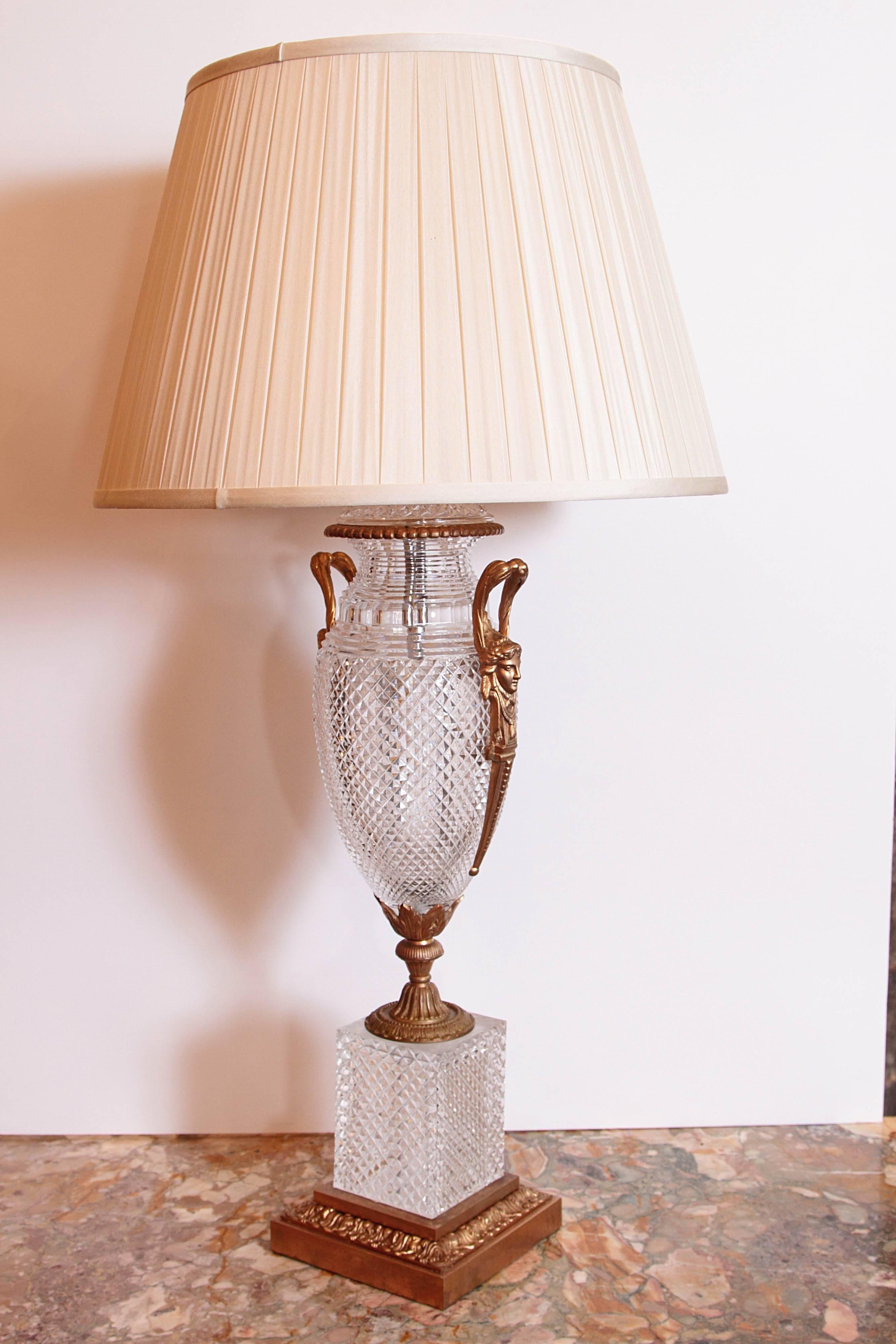 A pair of 19th century French cut crystal and gilt bronze urn lamps. Gilt bronze female head handles. Fine hand-cut crystal.