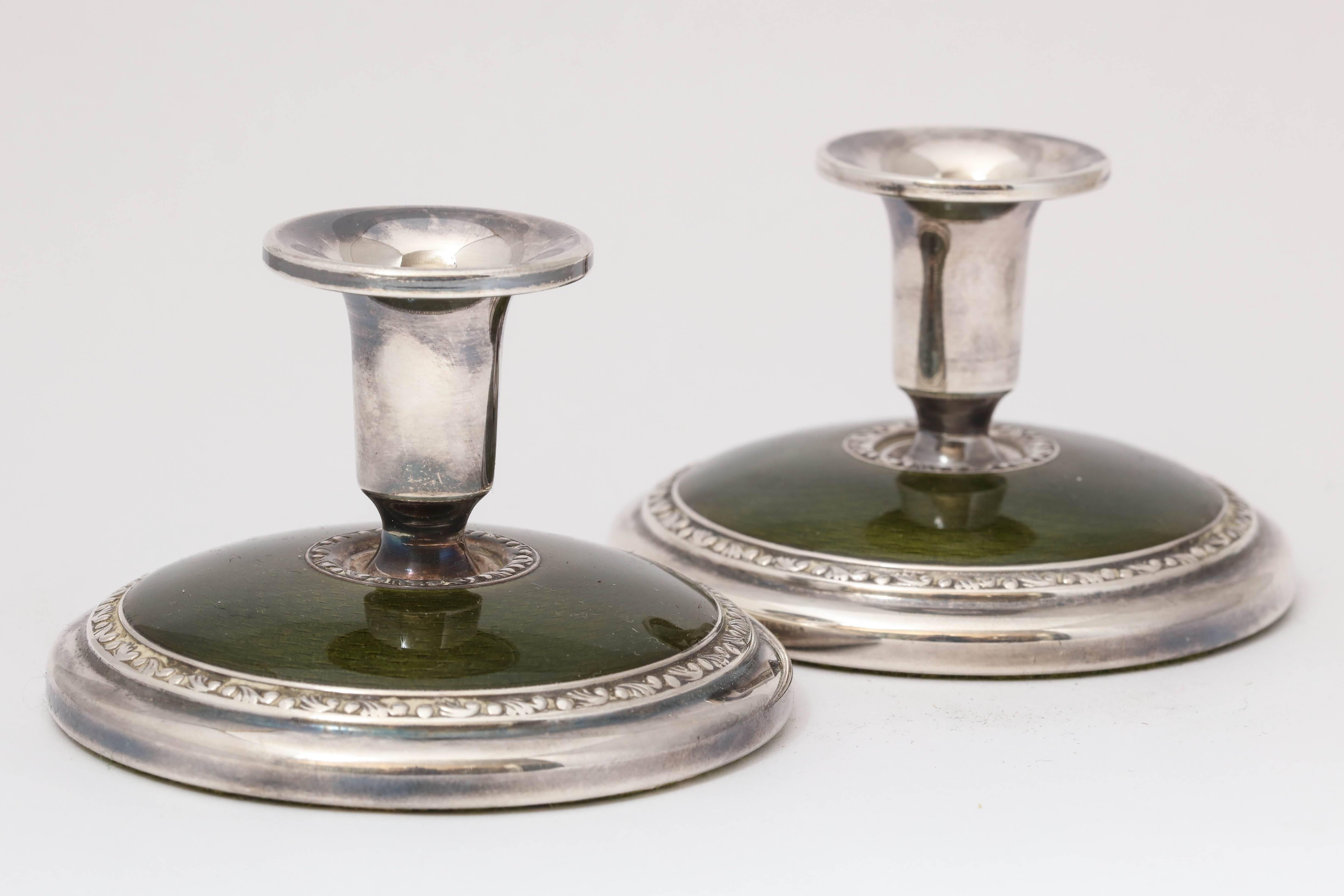 Pair of Art Deco, sterling silver and deep, olive green candlesticks, Norway, circa 1930s, Norsk Solwaaren Industri, makers. Measures: 2 inches high x 3 inches diameter (across base). Weighted. Dark spots are reflections. Excellent condition.