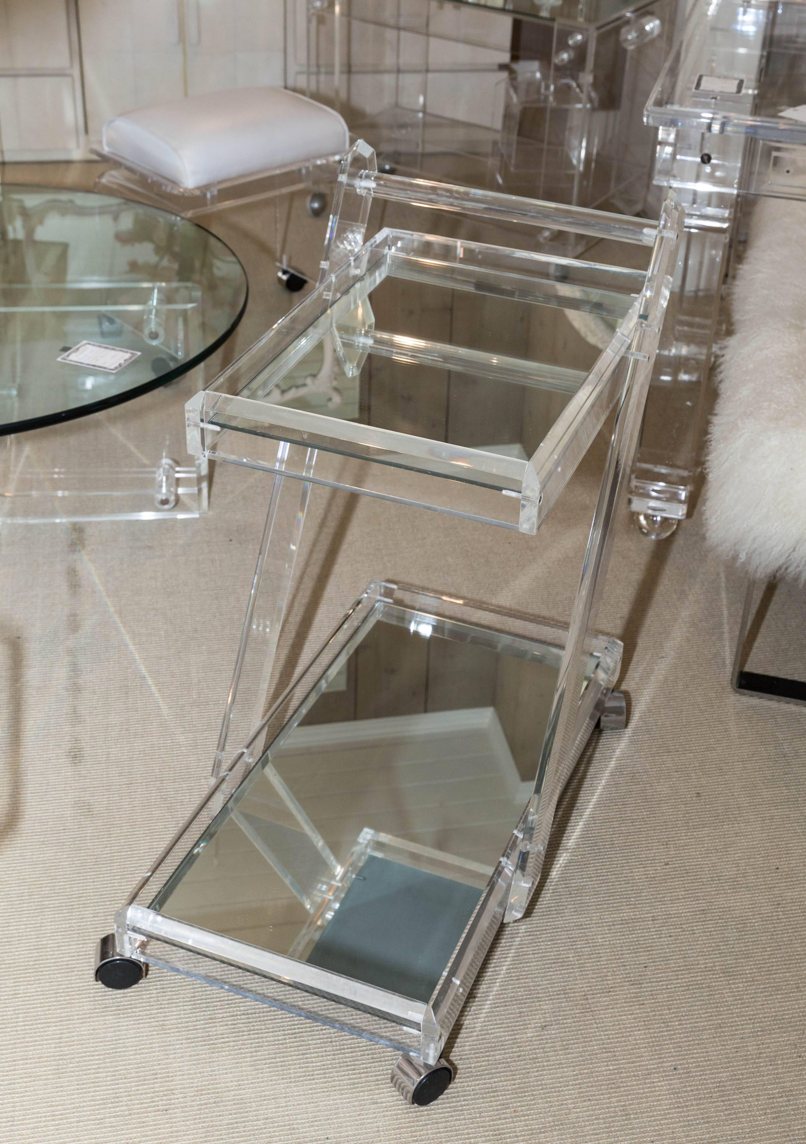 Attractive Mid-Century Lucite tea cart with two mirrored shelves.