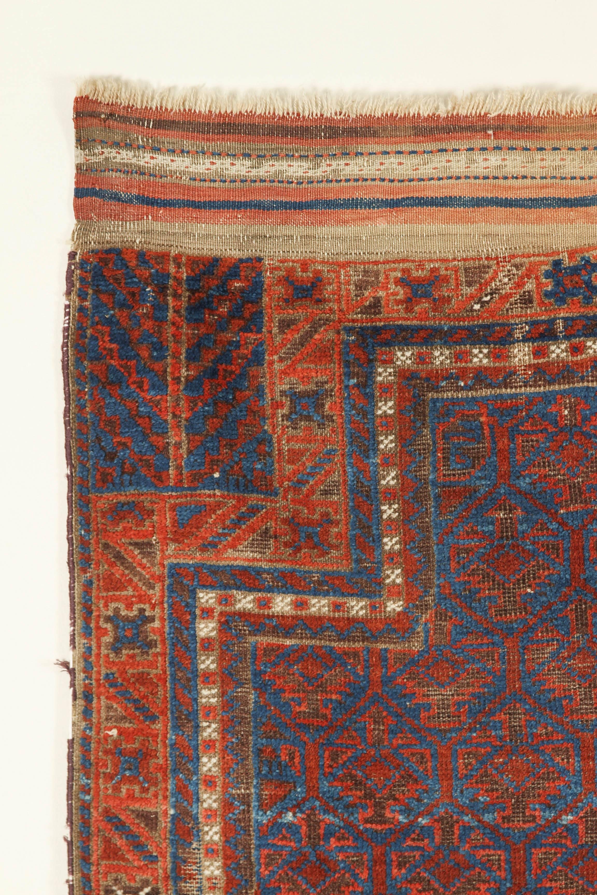Tribal Antique Baluchi Blue Field Rug with Orange and Ivory For Sale