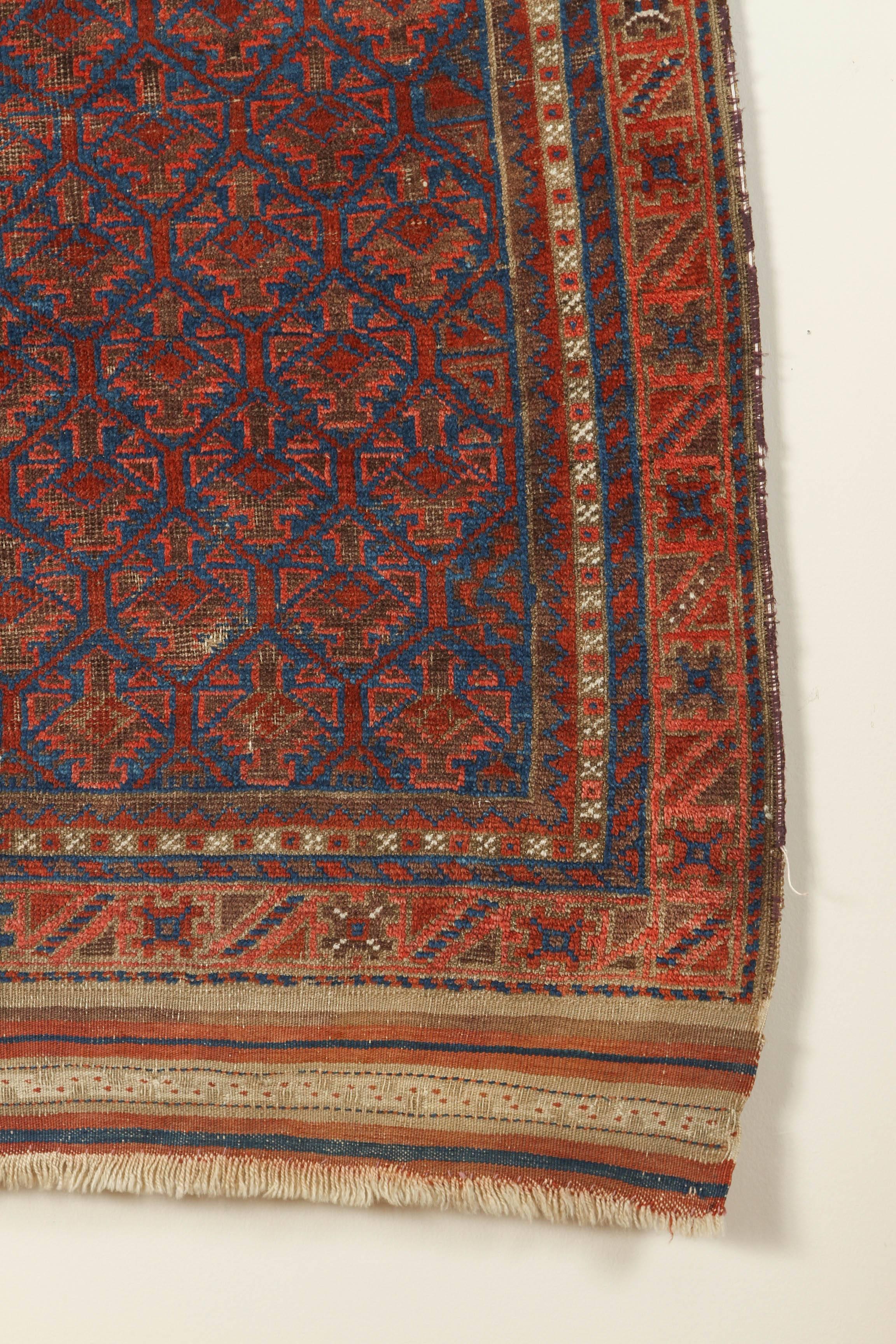 Afghan Antique Baluchi Blue Field Rug with Orange and Ivory For Sale