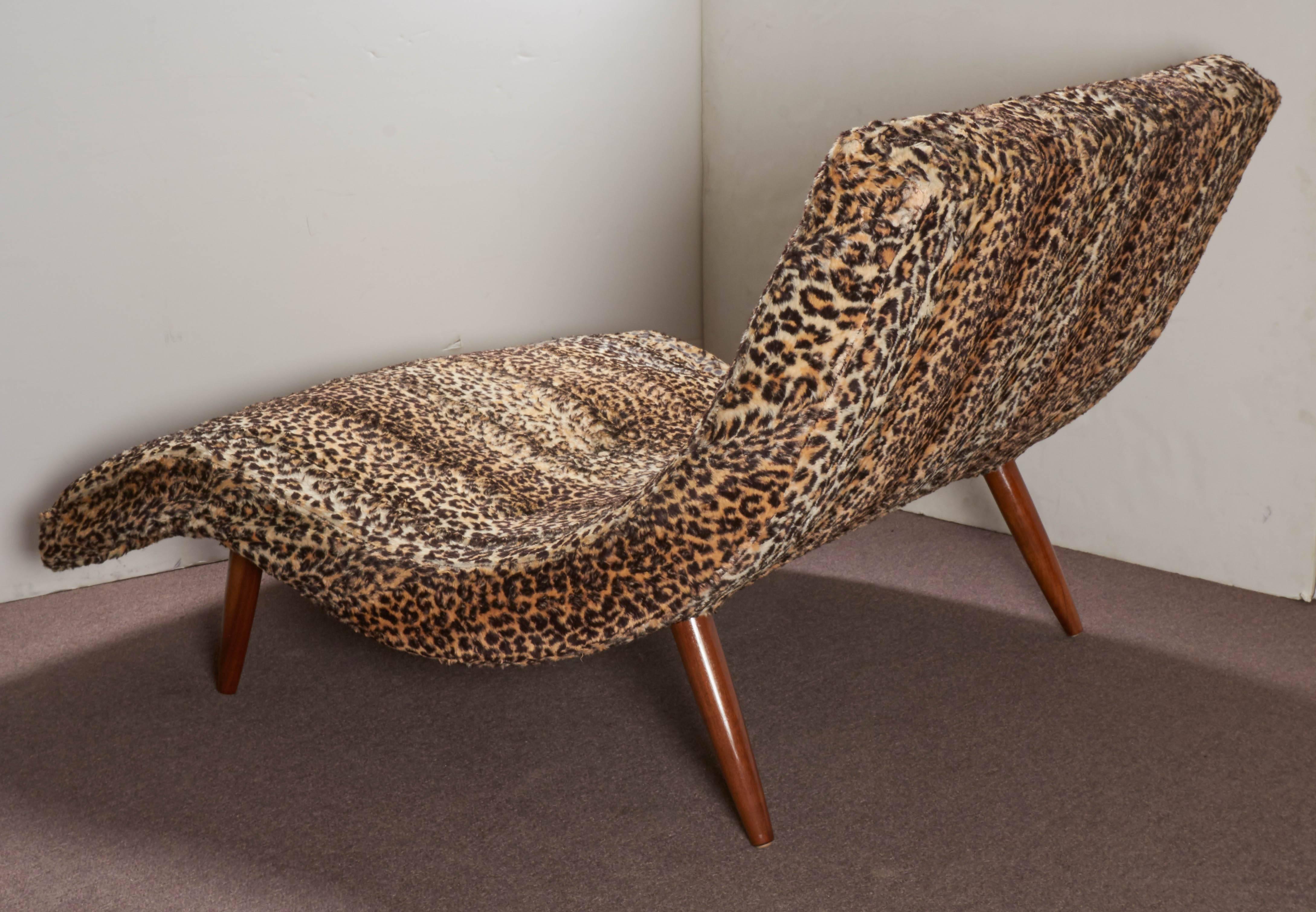 A modernist, wave design couples loveseat or recamier in the style of Adrian Pearsall in leopard faux fur. This comfortably designed seating area can accommodate either one or two people.
The tapered walnut legs are French polished and in good