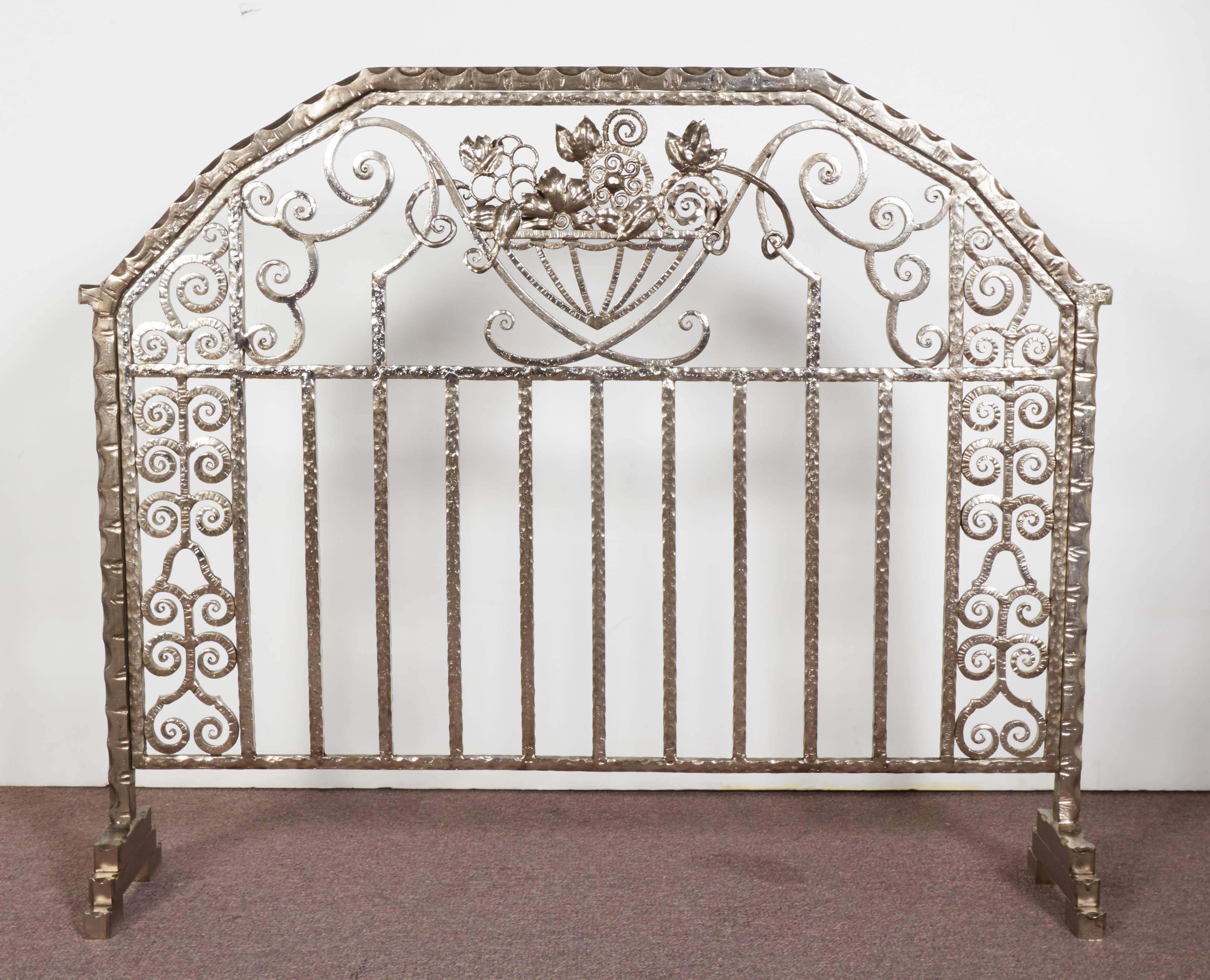 An exceptional pair of hand-forged iron Art Deco fire screens featuring overall linear and scroll detail with three dimensional central floral motif of superb martele hammering, unusually finished on both sides of the screen.
signed: J. Vanloo 
