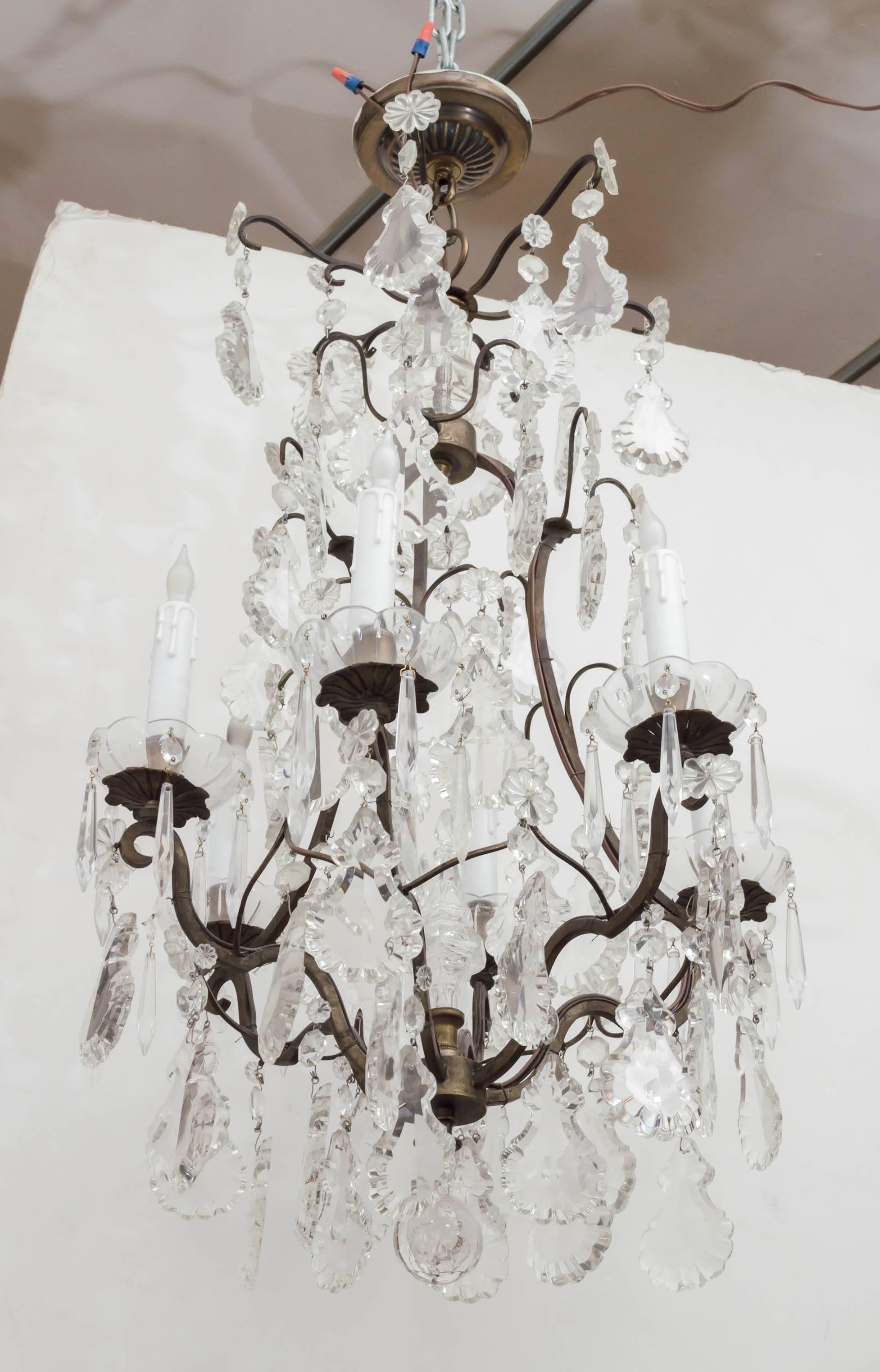 If you browse through our selection of antique lighting, you won't see any crystal chandeliers. We buy very little of them. This one caught our attention. It's the right size, has the large crystal segments, and is definitely an antique. Probably