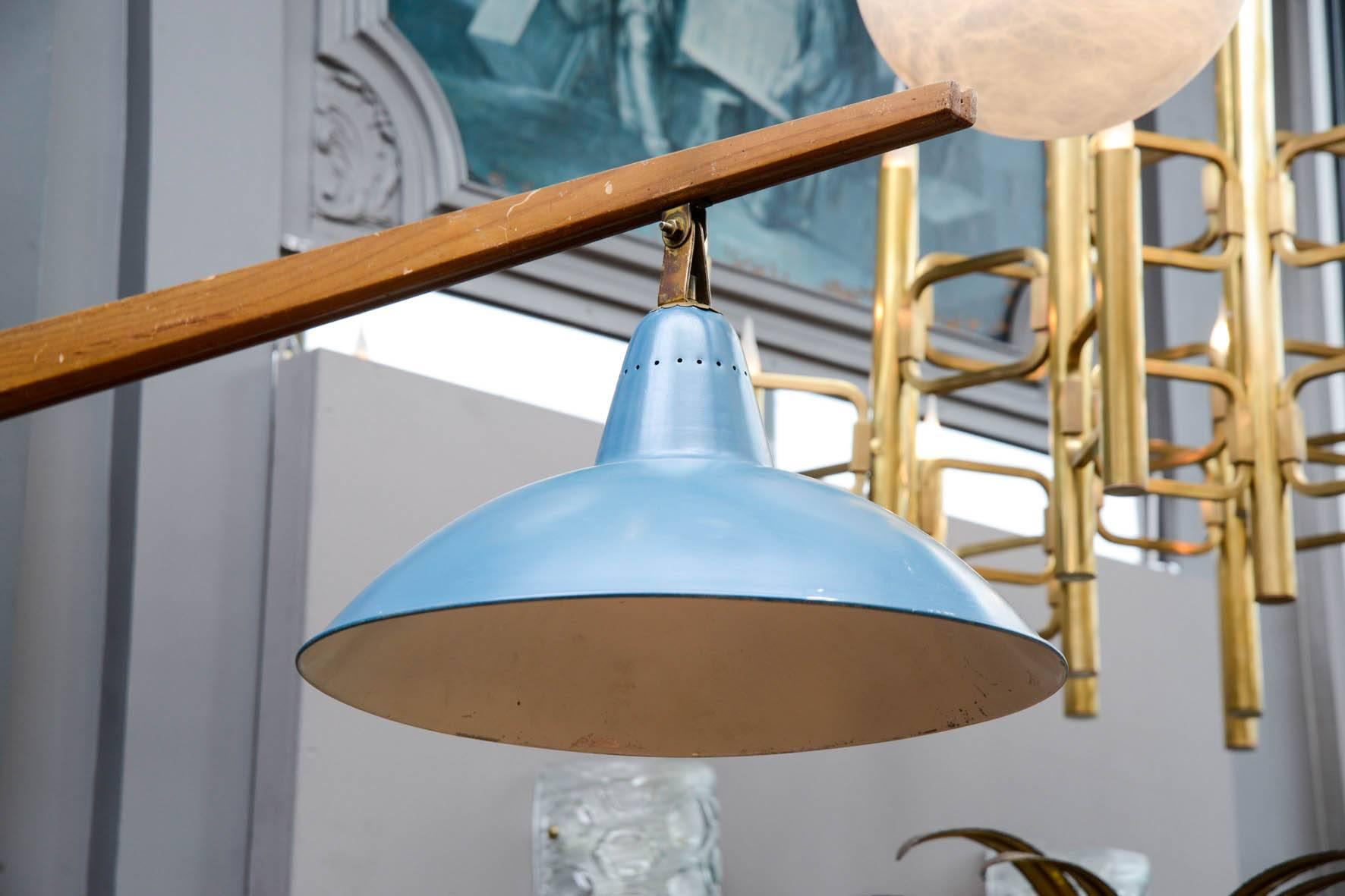 Unusual big wall sconce, made of a right angled wood structure finished by a blue enameled sconce.