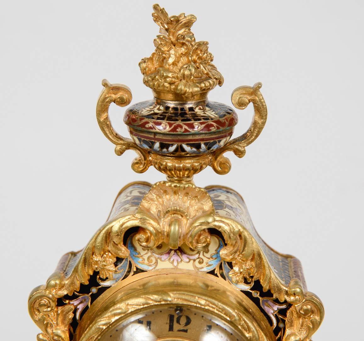 Rare clock enameled richly decorated with bronze golden.