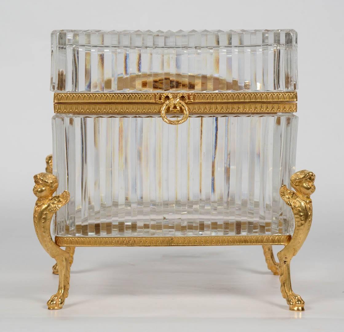 Impressive crystal box standing on four feet in the shape of angels in gilded bronze.