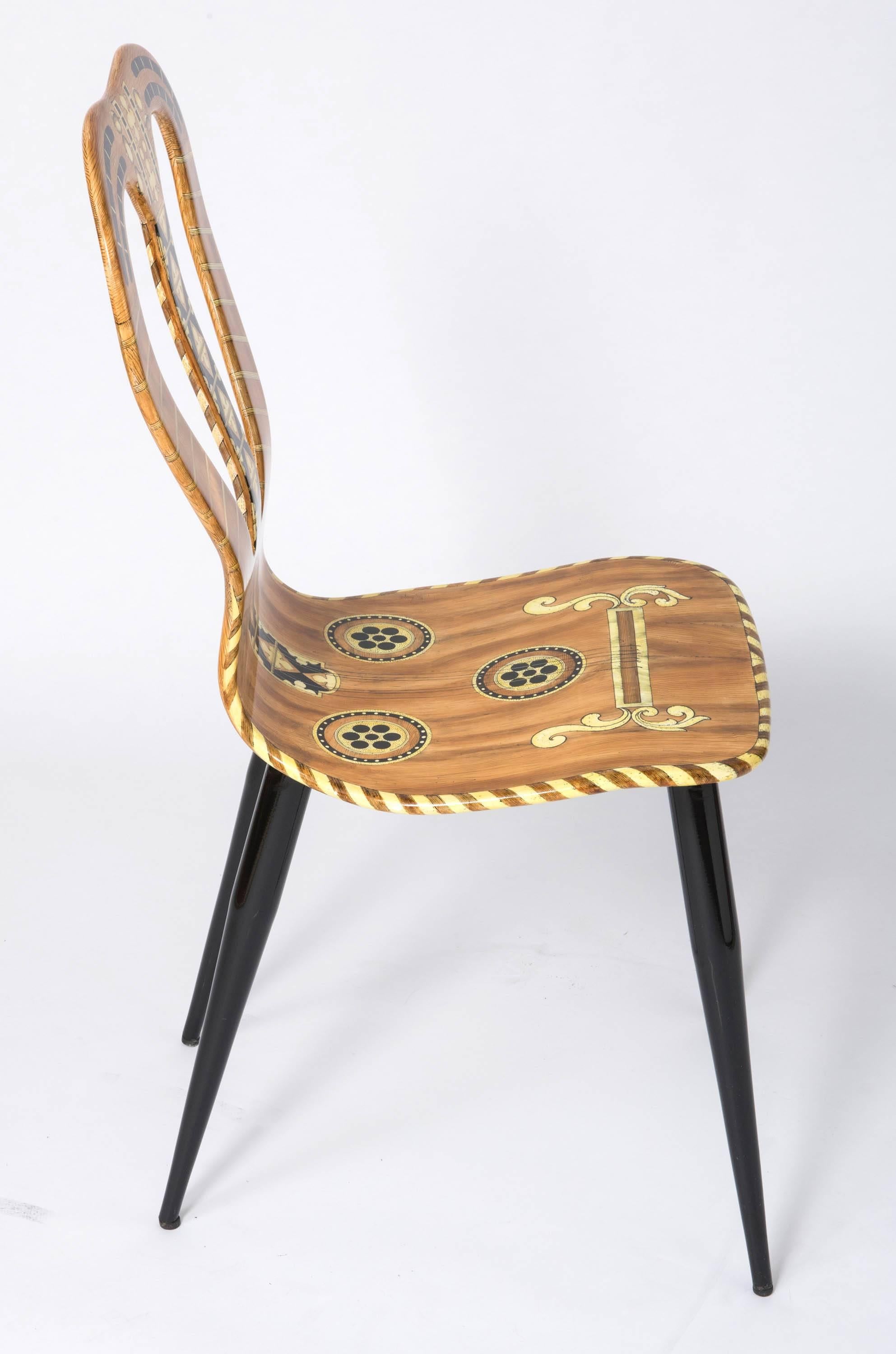 A “Musicale” chair by Atelier Fornasetti.
Lithographically printed. Hand coloured
Wood, lacquer, metal tubular legs.
Italy, 1989
Marked no. 16-60-89 Naty
95.5 cm high x 41 cm wide x 40 cm deep.
 