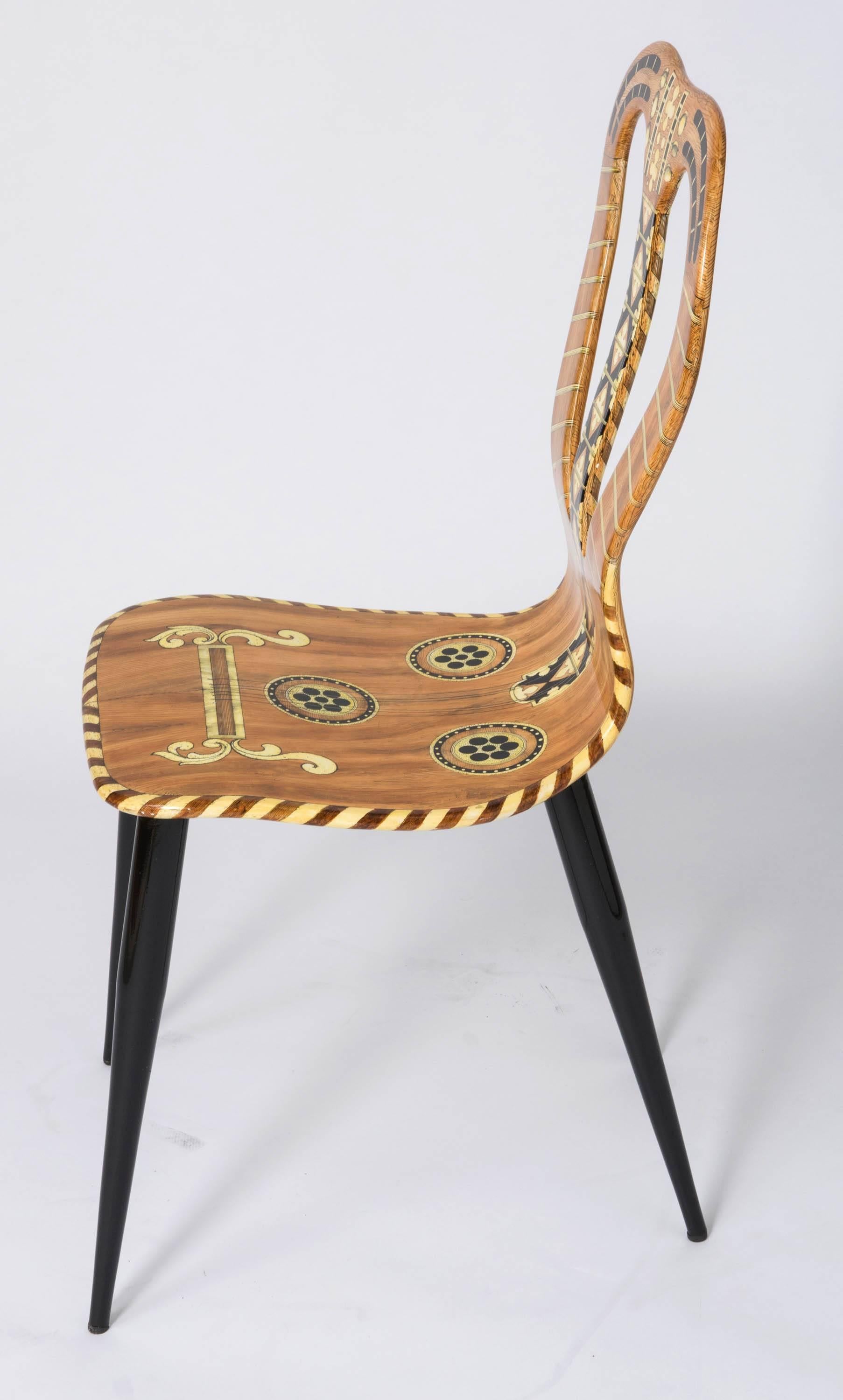 A “Musicale” chair by Atelier Fornasetti.
Lithographically printed. Hand coloured
wood, lacquer, metal tubular legs.
Italy, 1989
Marked no. 17/60/89 60
Measures: 95.5 cm high x 41 cm wide x 40 cm deep.
 